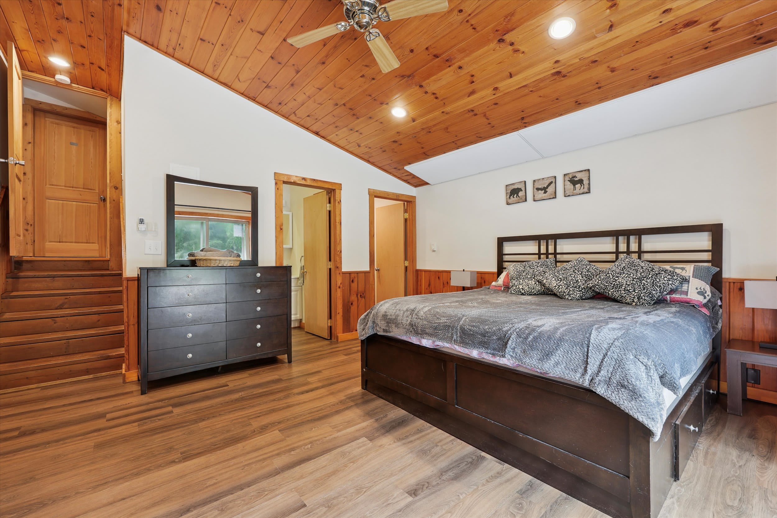 Drift off to sleep in this cozy cedar-paneled bedroom with plush bedding.