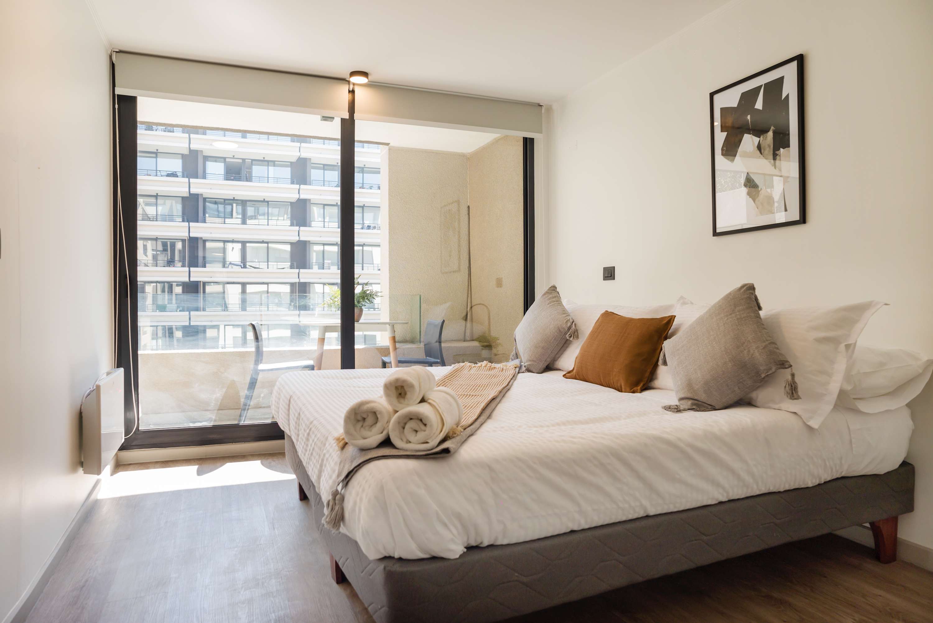 Relax in this cozy bedroom with a private balcony, perfect for enjoying morning coffee with a view.