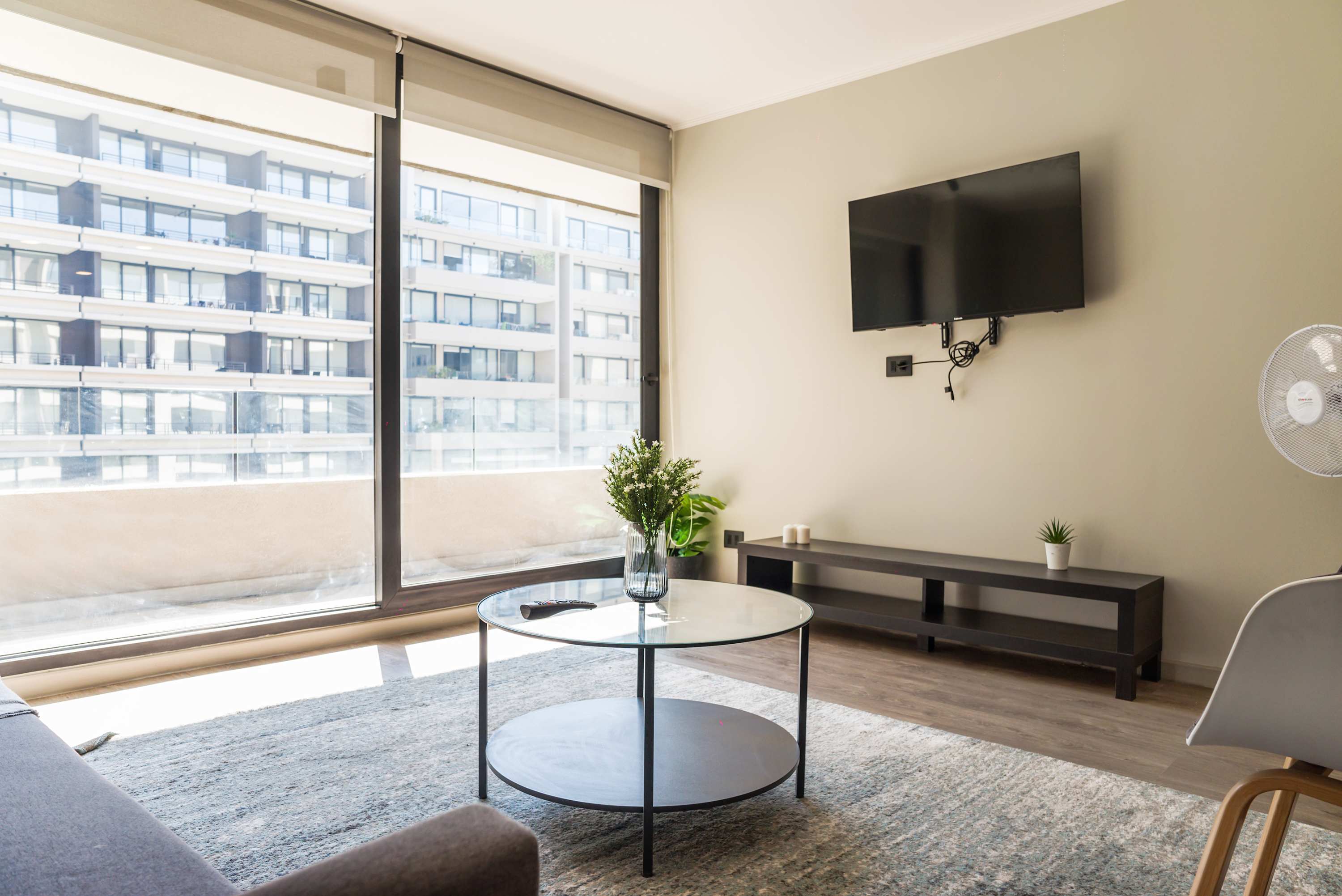 Bright and modern living space with a large window view, perfect for relaxation and entertainment.