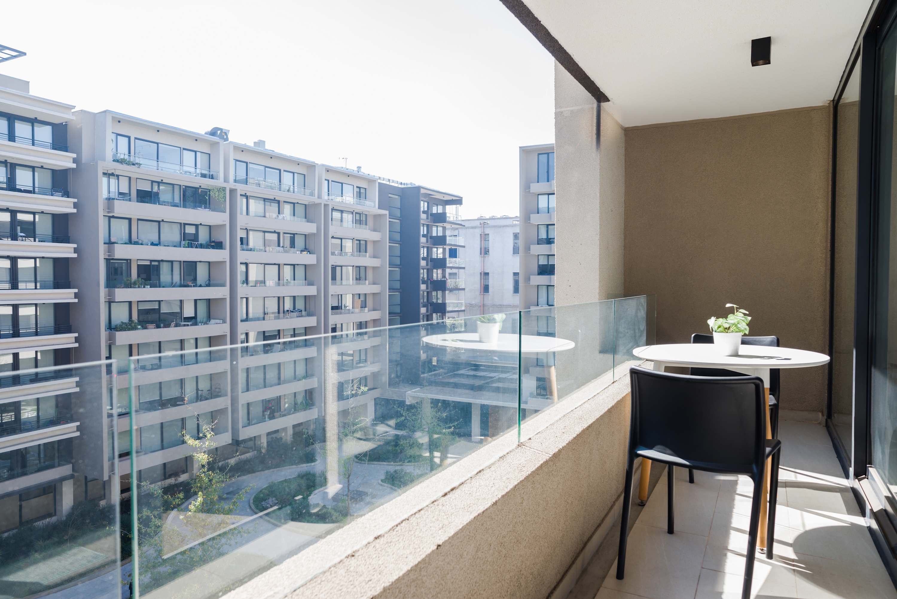Enjoy your morning coffee on this serene balcony with a view of the cityscape.