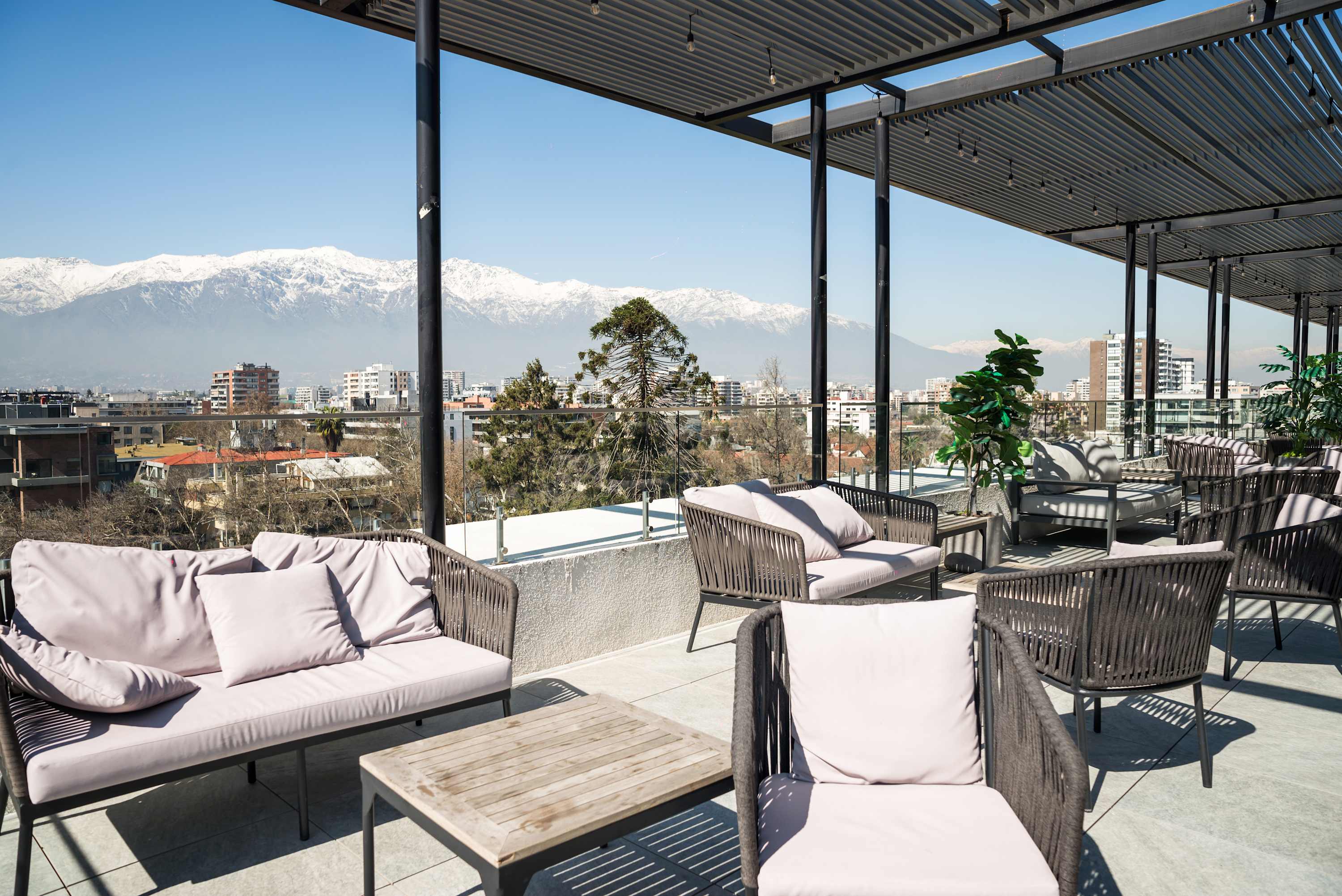 Relax in style with breathtaking city and mountain views from this chic outdoor lounge area.