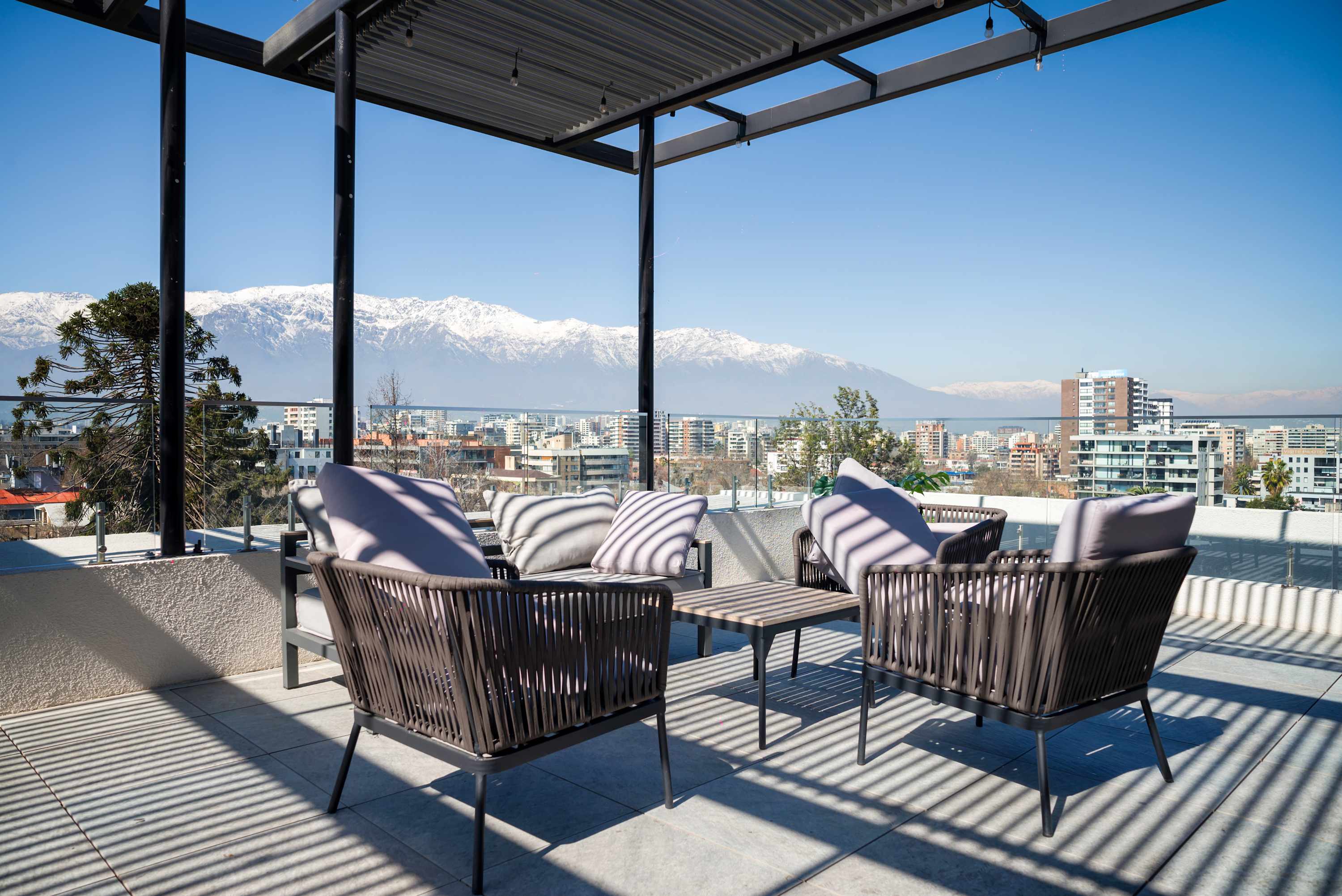 Relax on the rooftop patio with breathtaking views of the city and Andes mountains, perfect for unwinding or socializing.