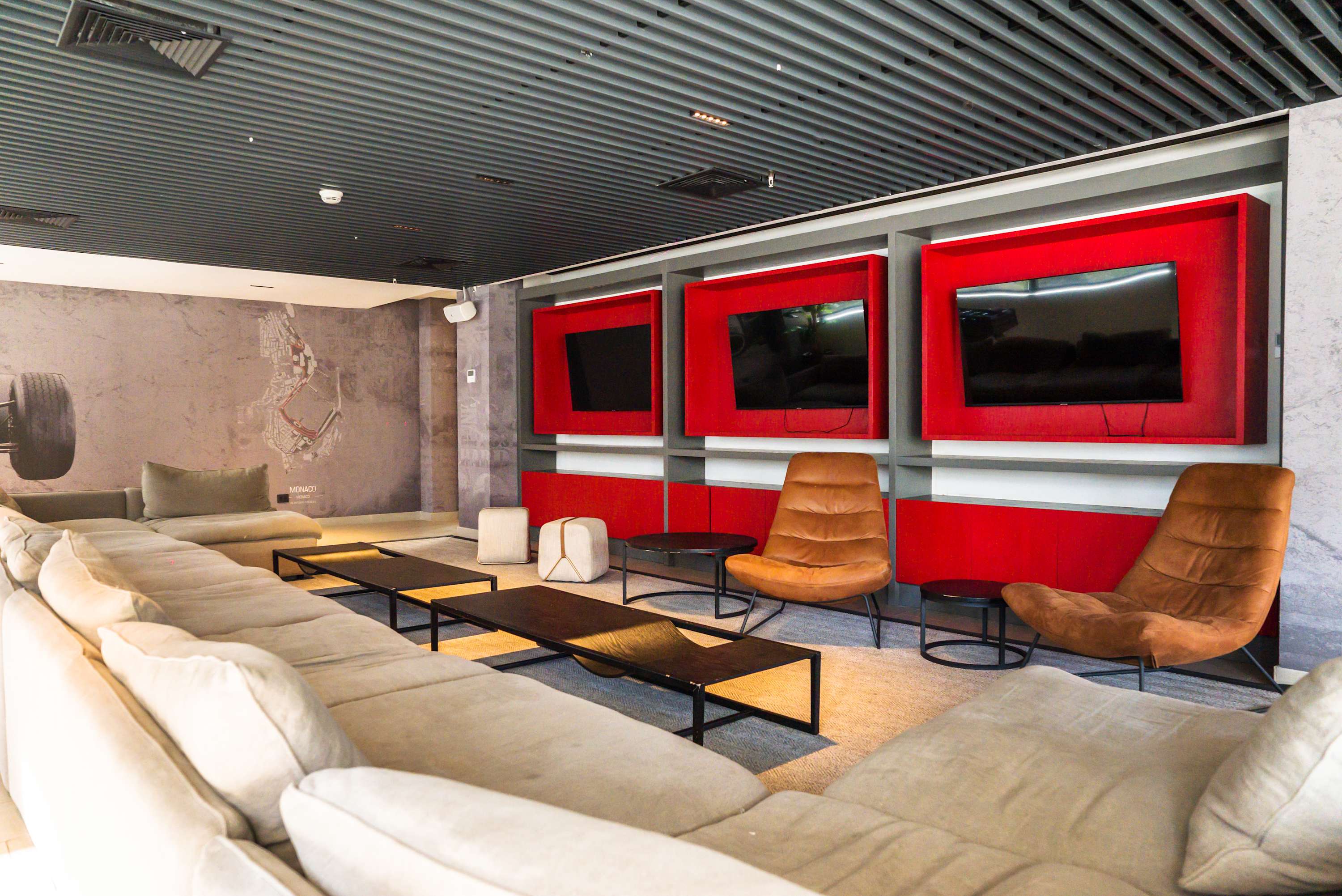 Relax in this modern lounge with multiple TVs and comfy seating, perfect for unwinding after a day of exploring.