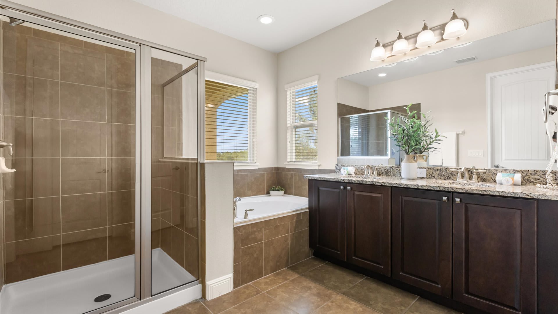 King Bedroom en-suite bathroom with double vanity, standing shower and bathtub