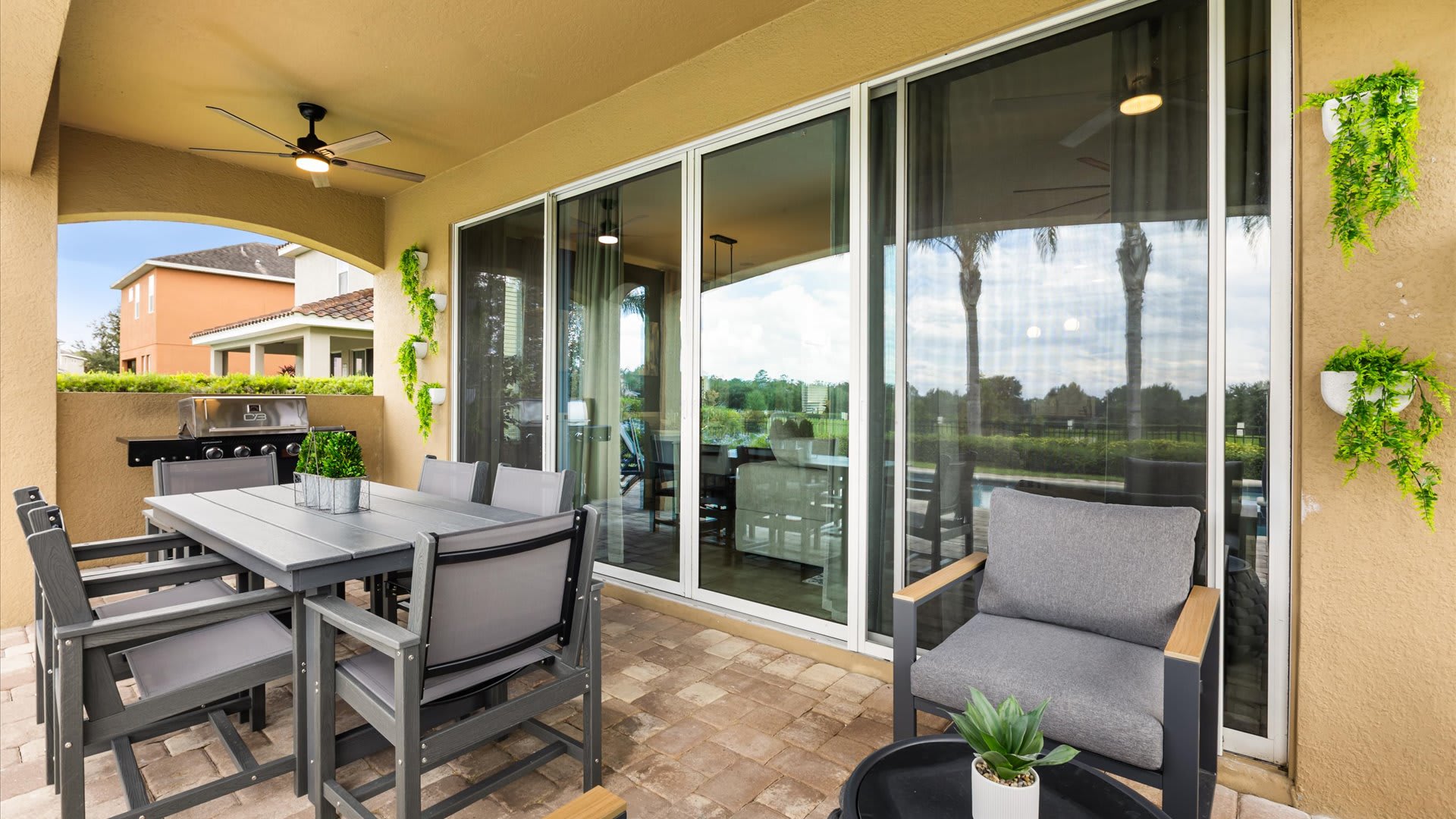 Outdoor patio with dining area and BBQ grill