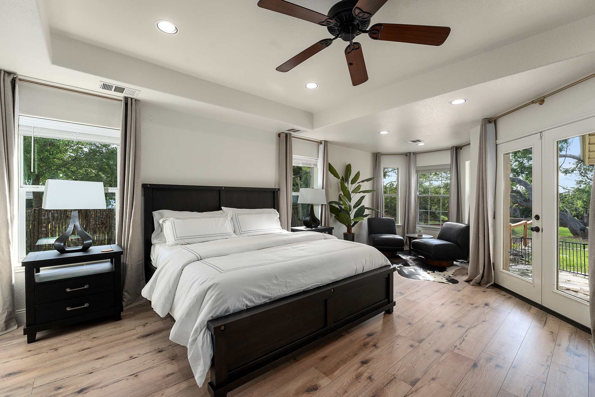 Spacious King suite featuring a seating nook, deck entry, and smart TV