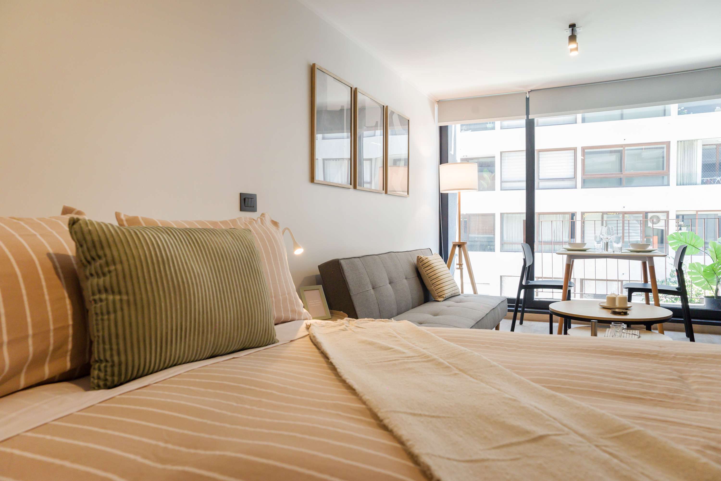 Relax in this bright, modern studio with cozy seating and dining area, perfect for unwinding after a day exploring the city.