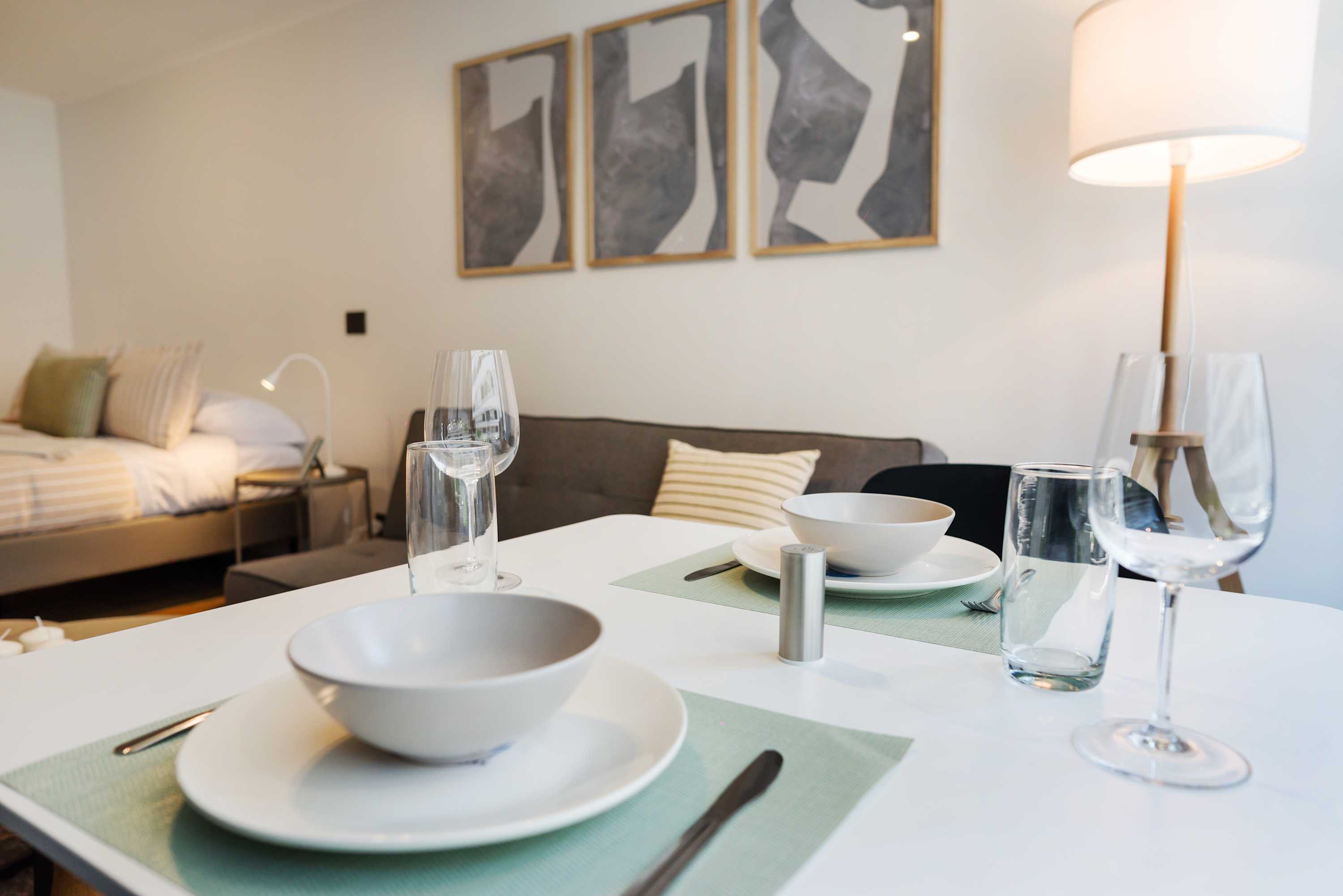 Modern dining setup in a cozy studio, perfect for intimate meals and relaxation.