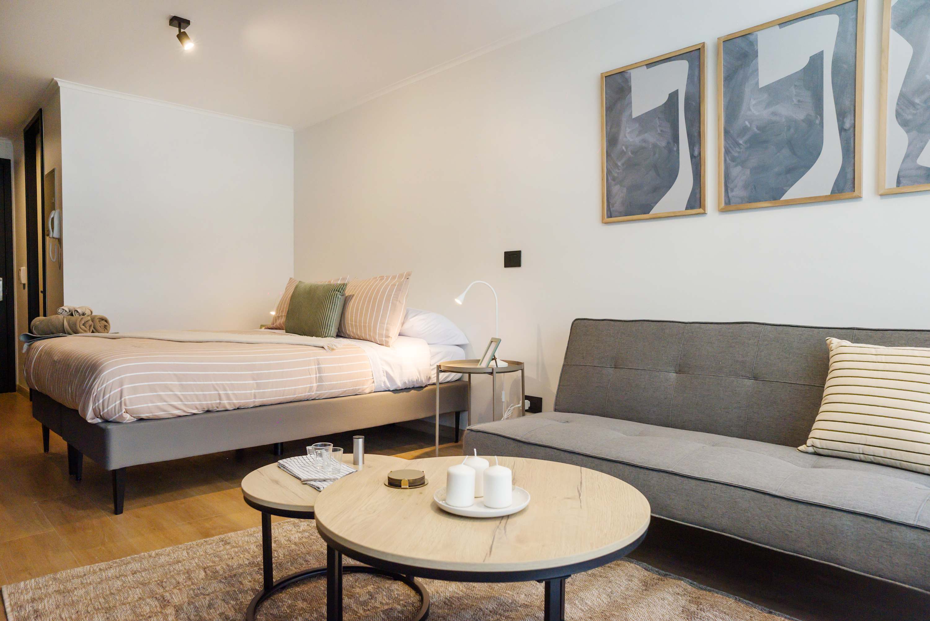 Modern studio with cozy bed and stylish decor, perfect for a relaxing stay in Chile's vibrant heart.