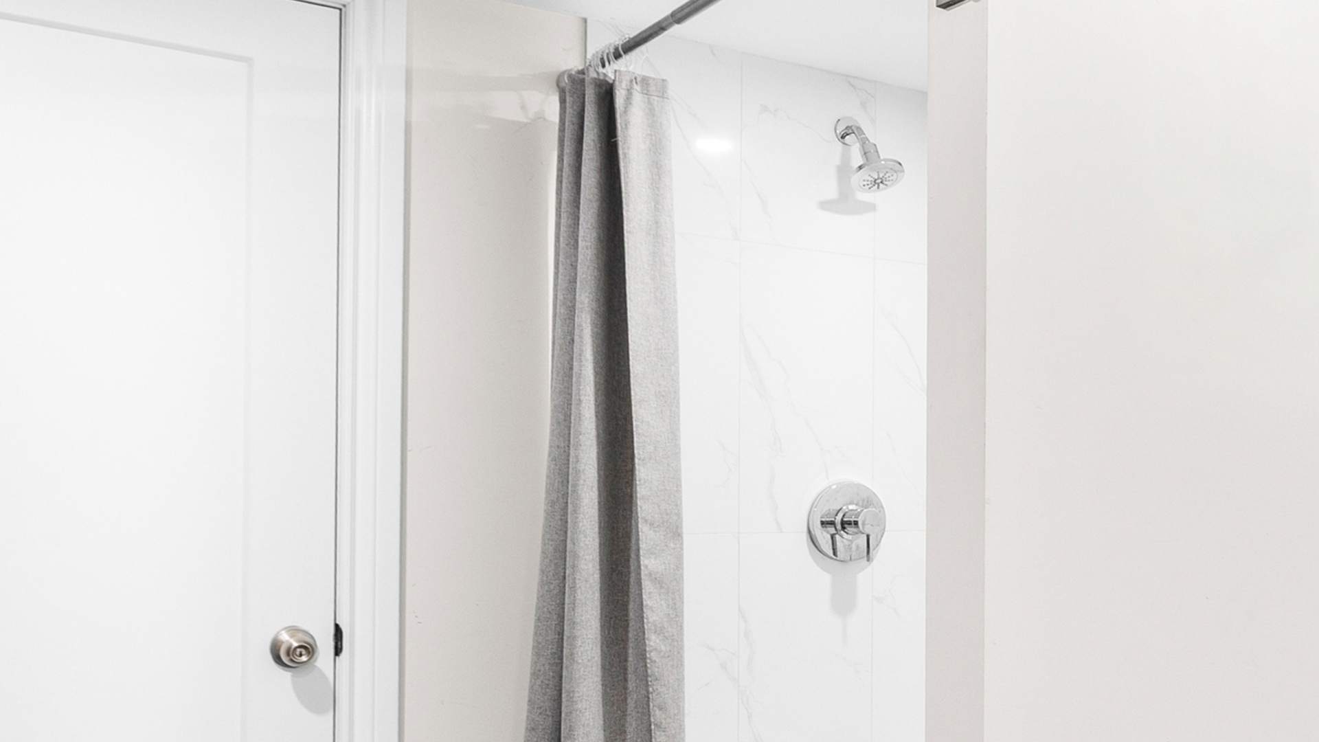 Fresh, modern bathroom with a walk-in shower and essentials provided.