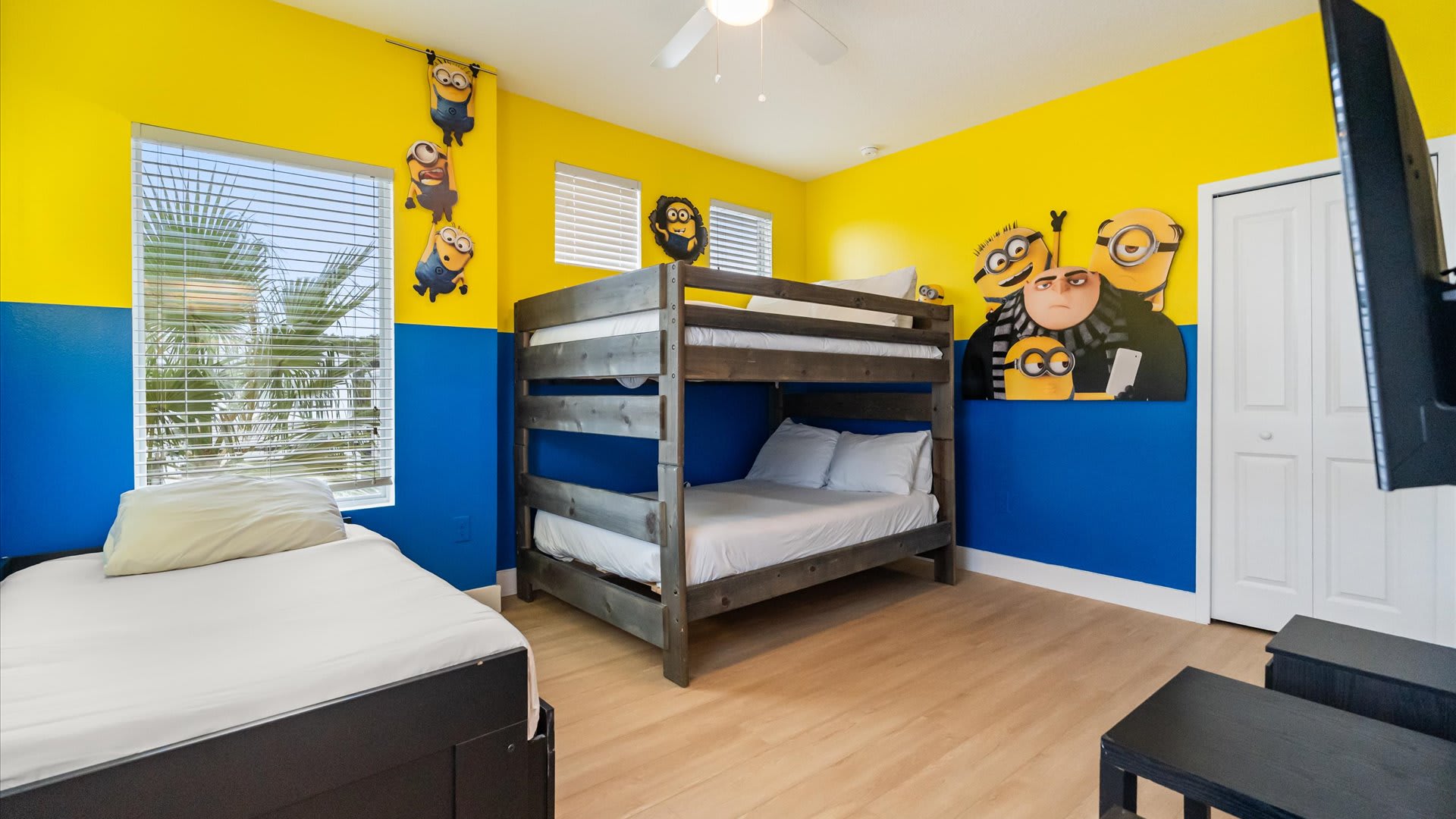 Minions bedroom with 2 full bunk beds and a smart TV