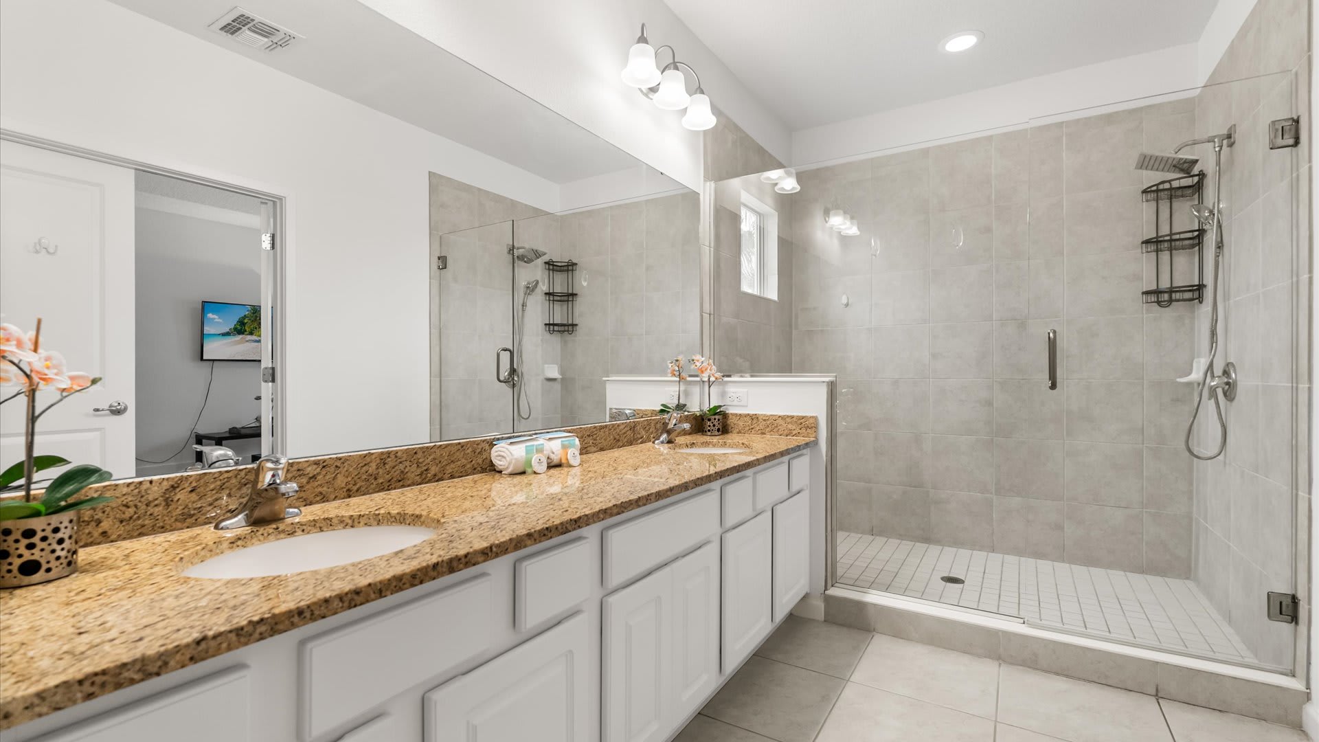 Spacious en-suite bathroom with standing shower and double vanity