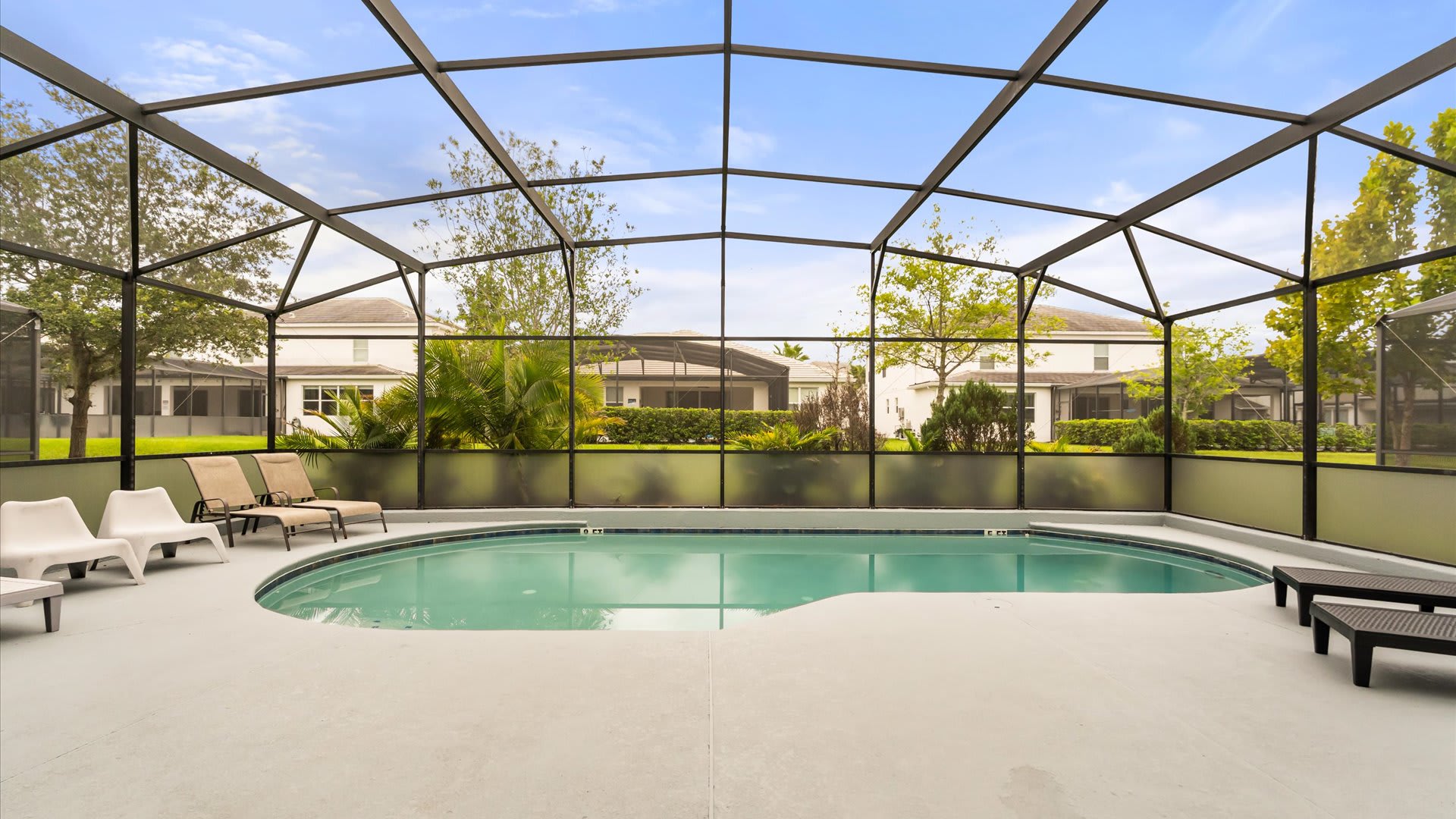 Refreshing outdoor swimming pool with sun loungers