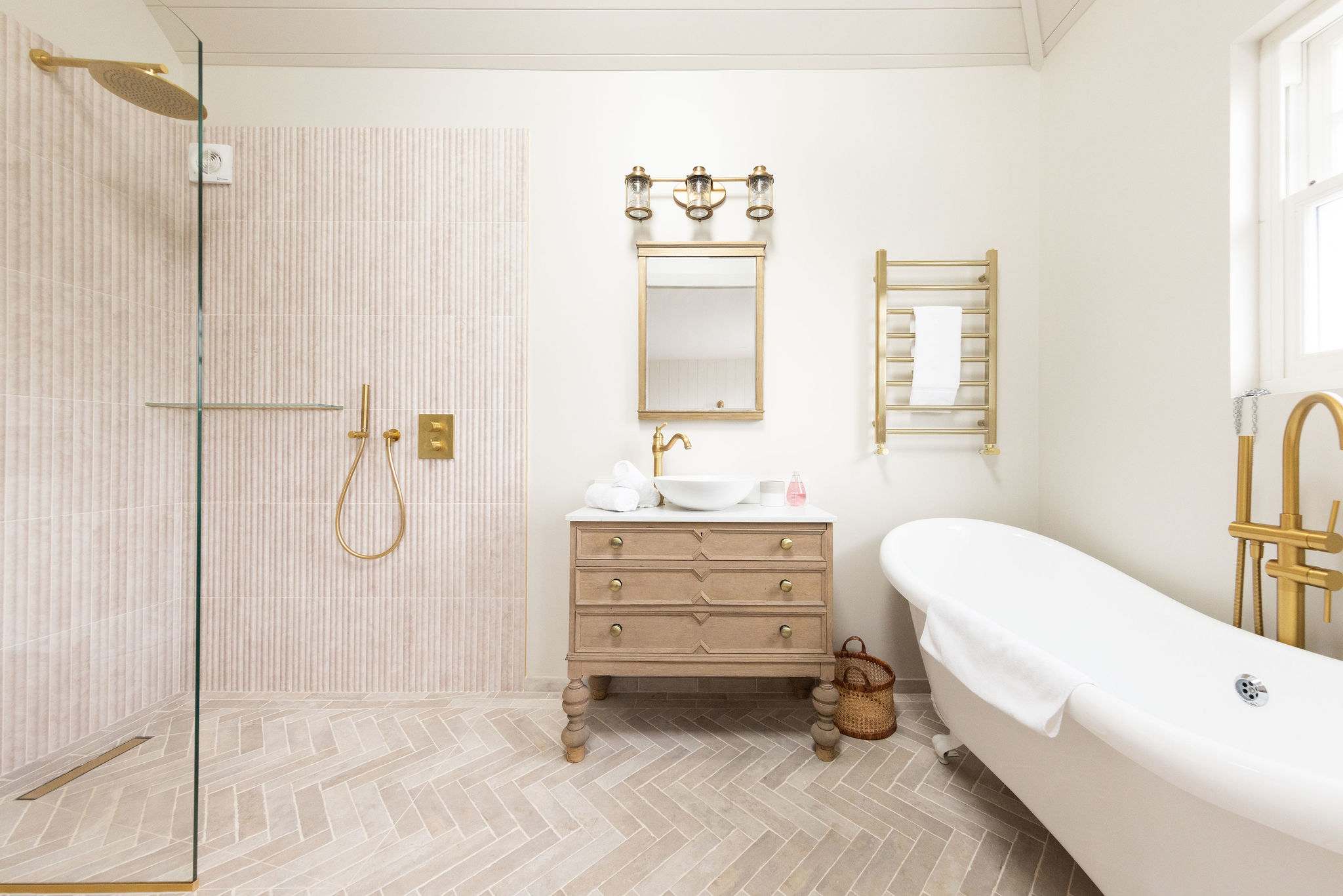 A luxurious, spa-like bathroom with a walk-in shower and deep, free standing bath.