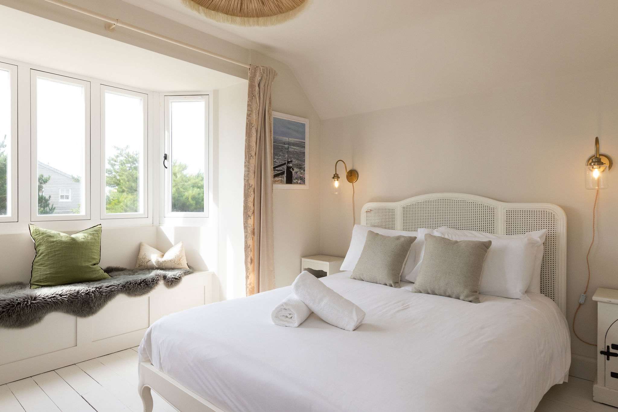 This king bedroom, complete with window seat, is beautifully furnished and decorated.