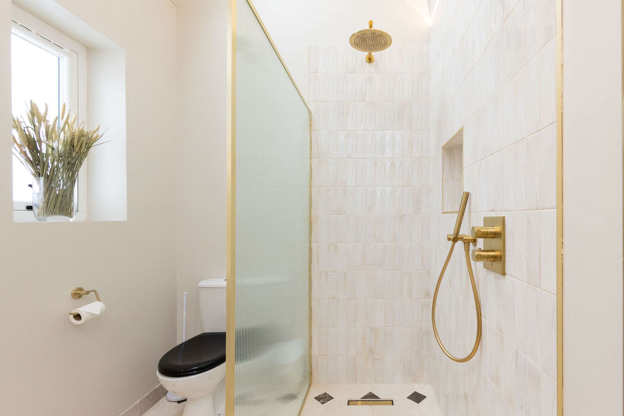 A modern family bathroom with a walk-in rainfall shower.