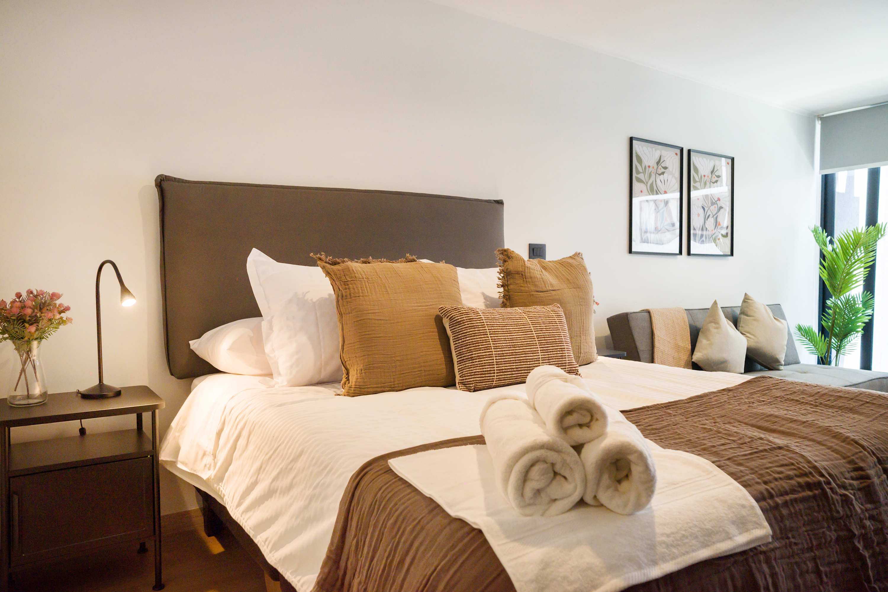 Relax in this stylish studio with plush bedding, modern decor, and ample natural light for a serene stay.