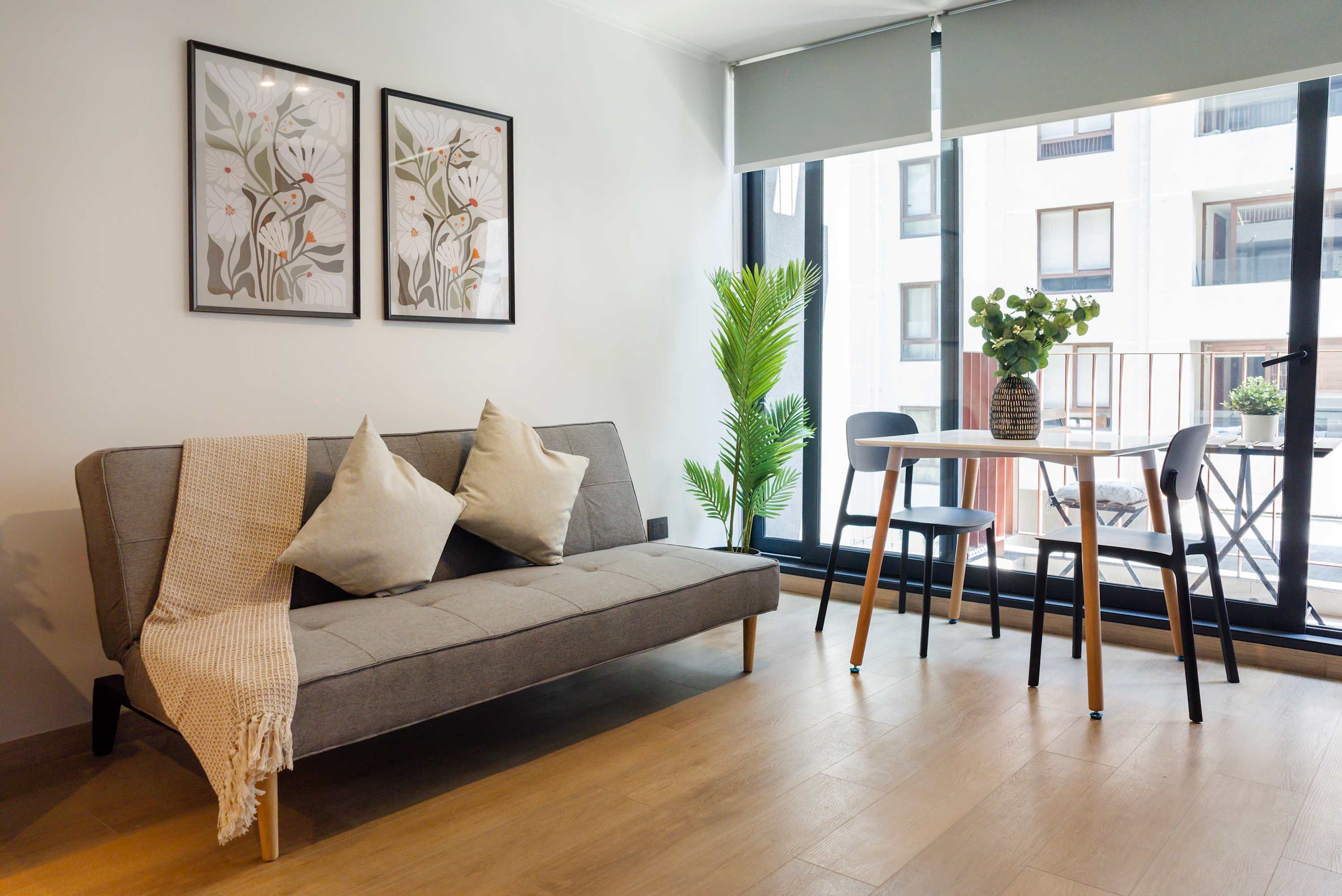 Modern and bright living area with cozy seating and dining space, perfect for relaxation and enjoying natural light.