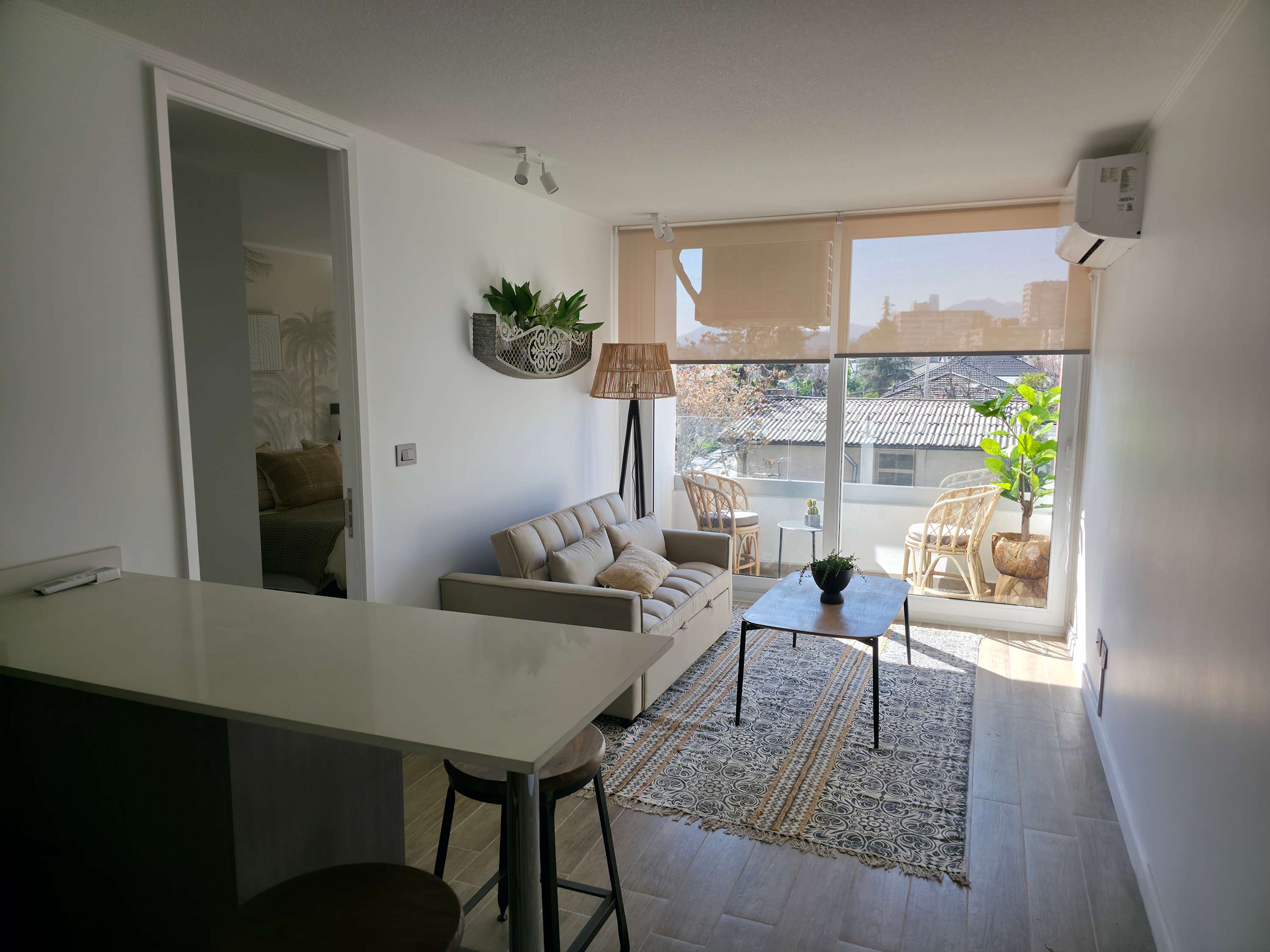 Bright and cozy living area with a charming balcony view, perfect for relaxation in this stylish studio apartment.