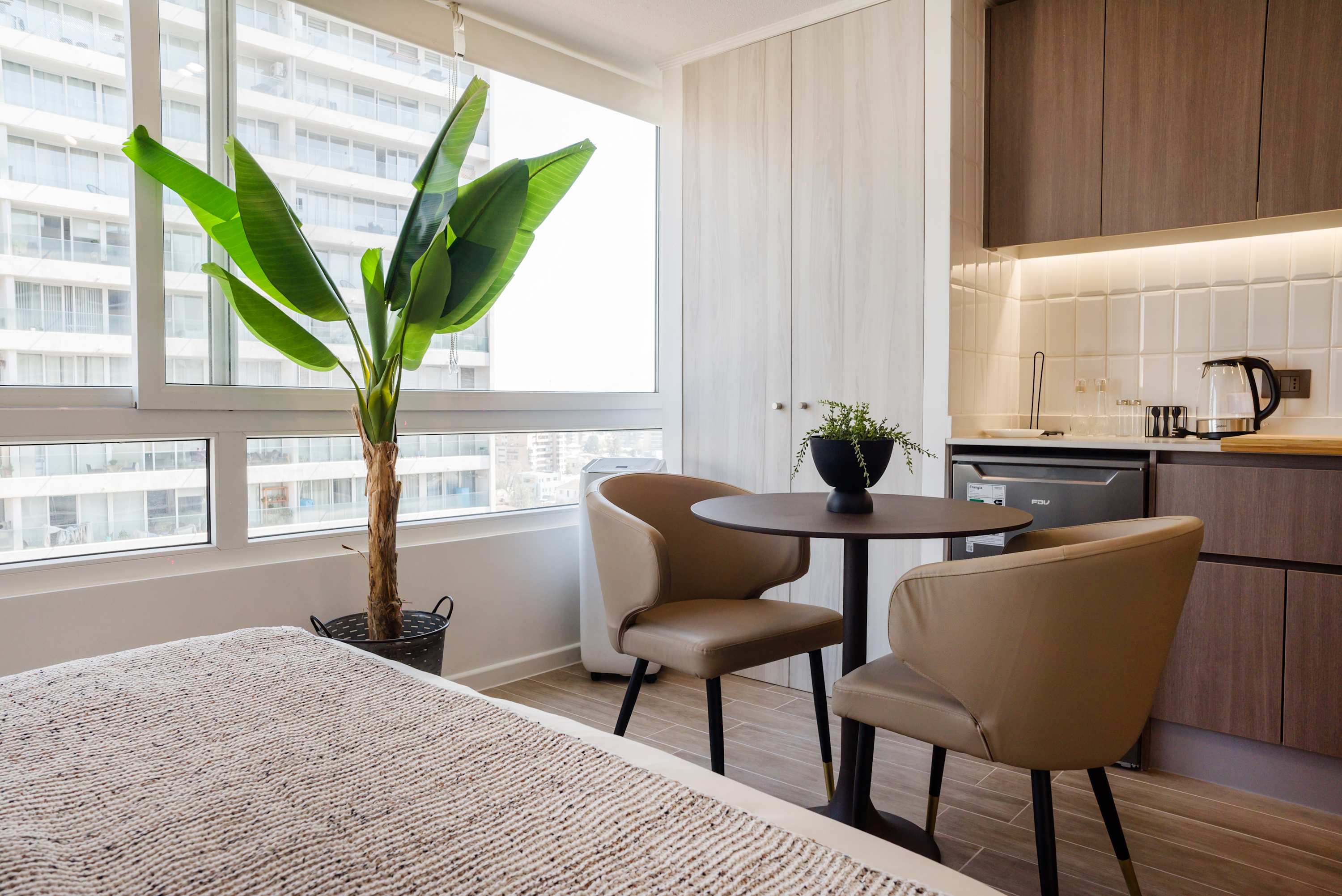 Bright and cozy dining nook with a view, perfect for enjoying a morning coffee in this stylish studio apartment.