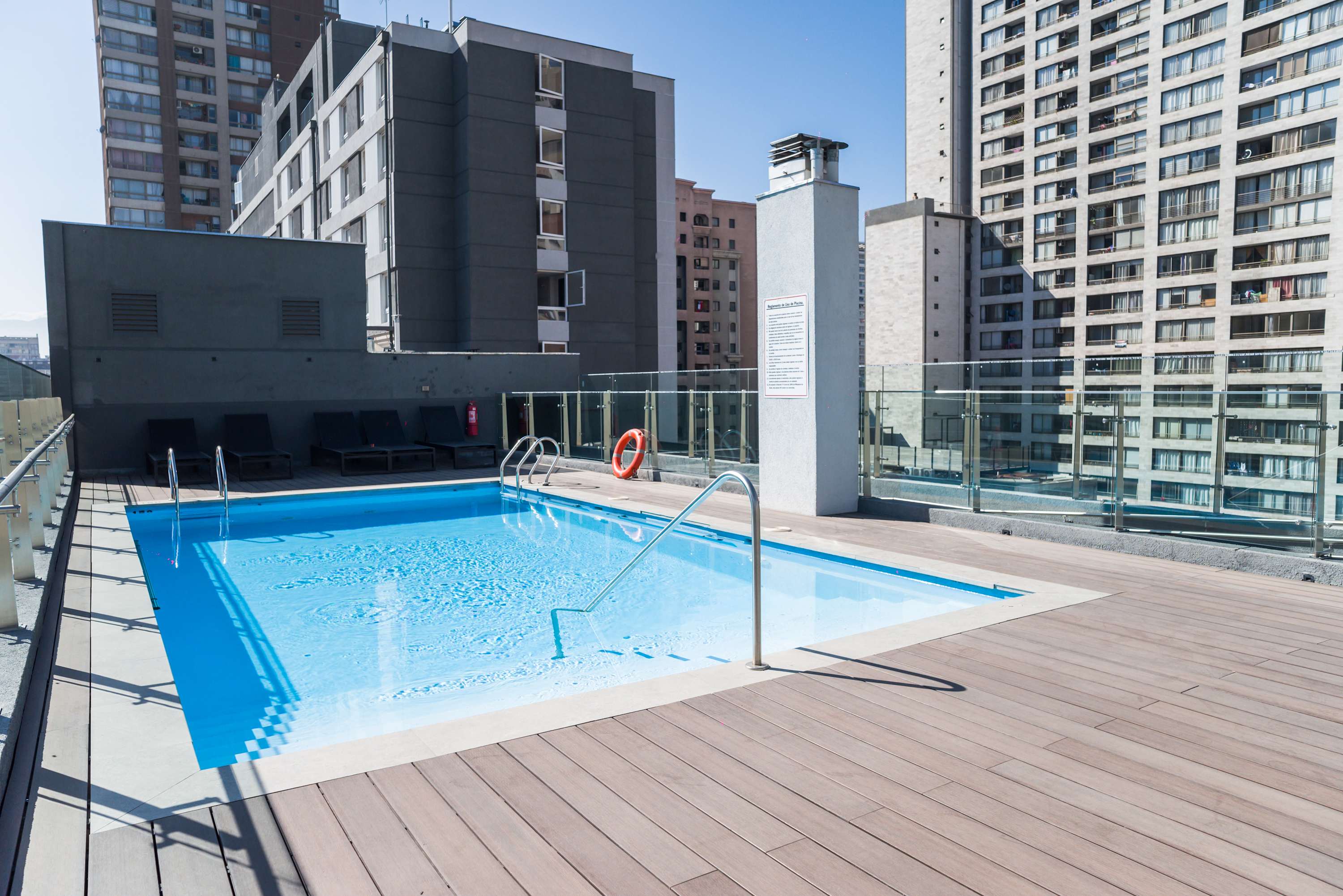 Relax by the rooftop pool with stunning city views, perfect for unwinding after a day of exploring. (Common Area)