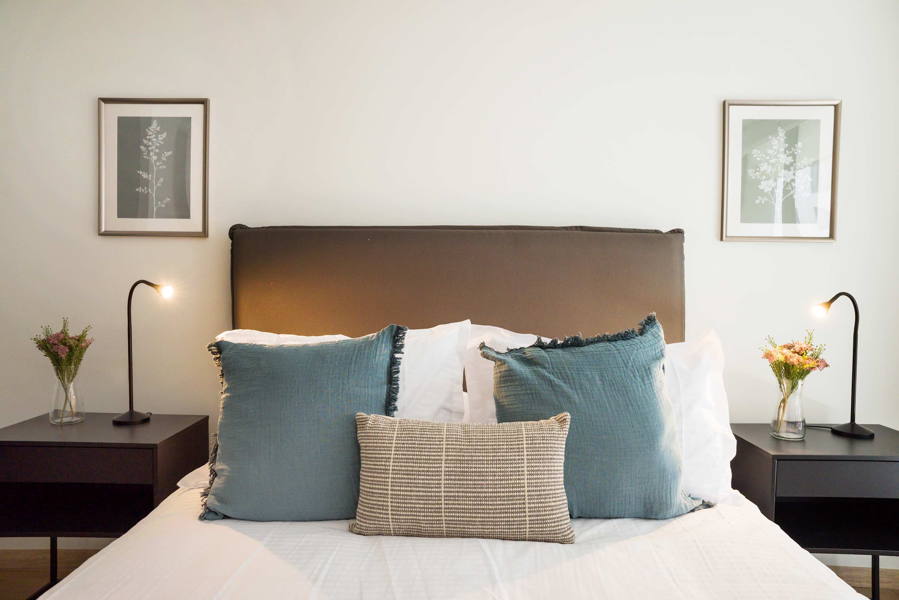 Relax in this serene bedroom with chic decor and ambient lighting, perfect for a peaceful retreat.