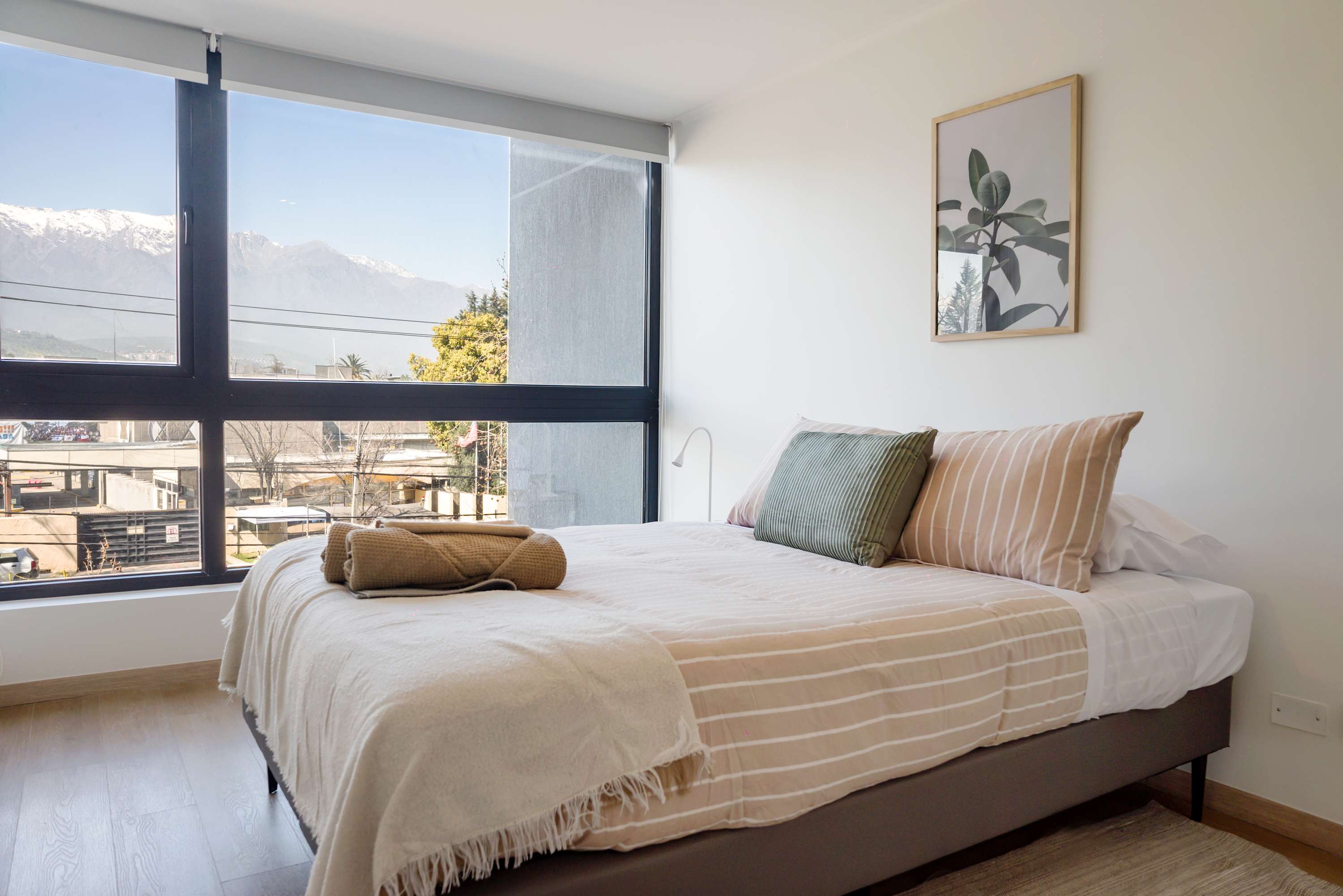 Relax in this cozy bedroom with breathtaking mountain views, perfect for unwinding after a day of exploring.