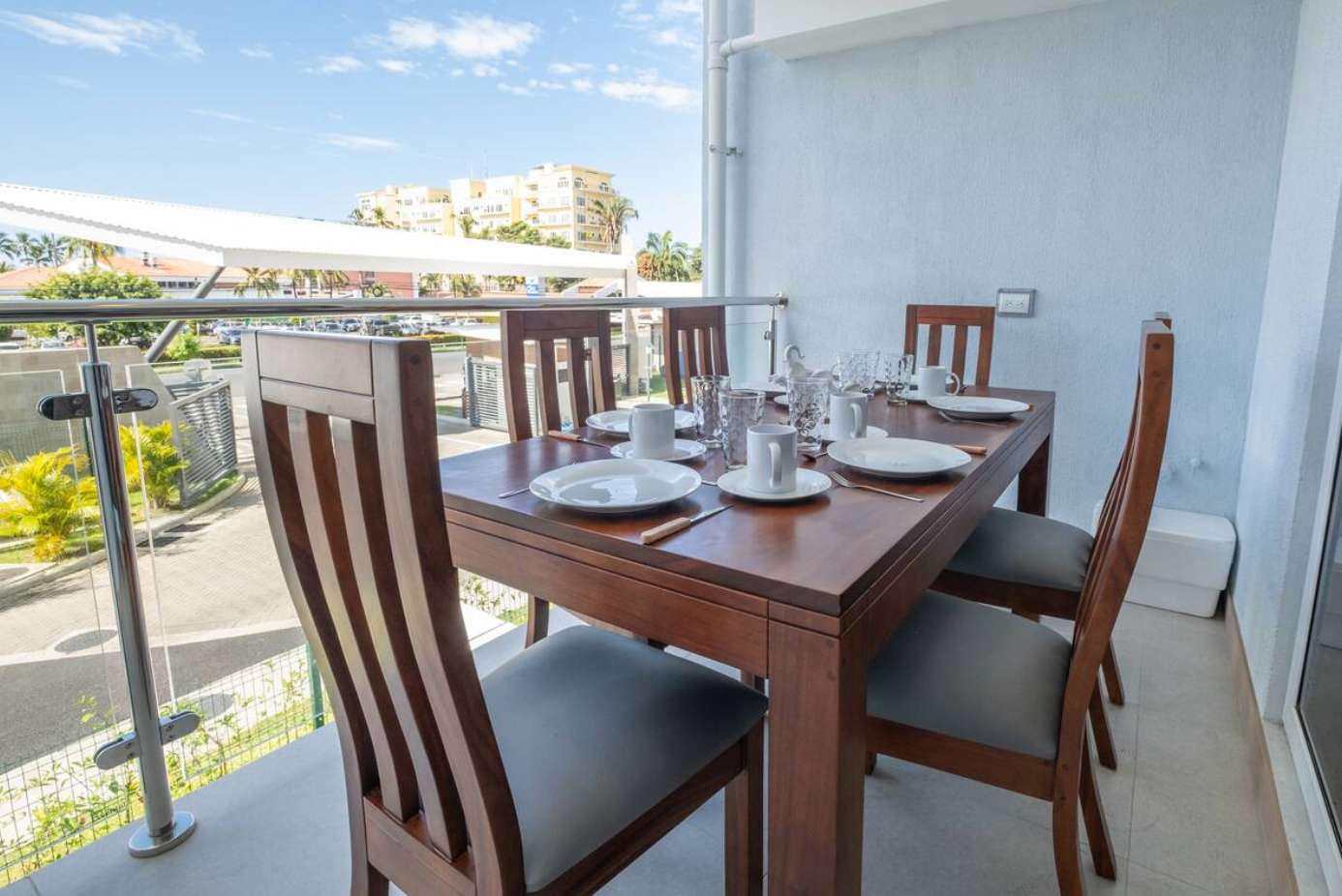 Outdoor balcony dining area with refreshing views