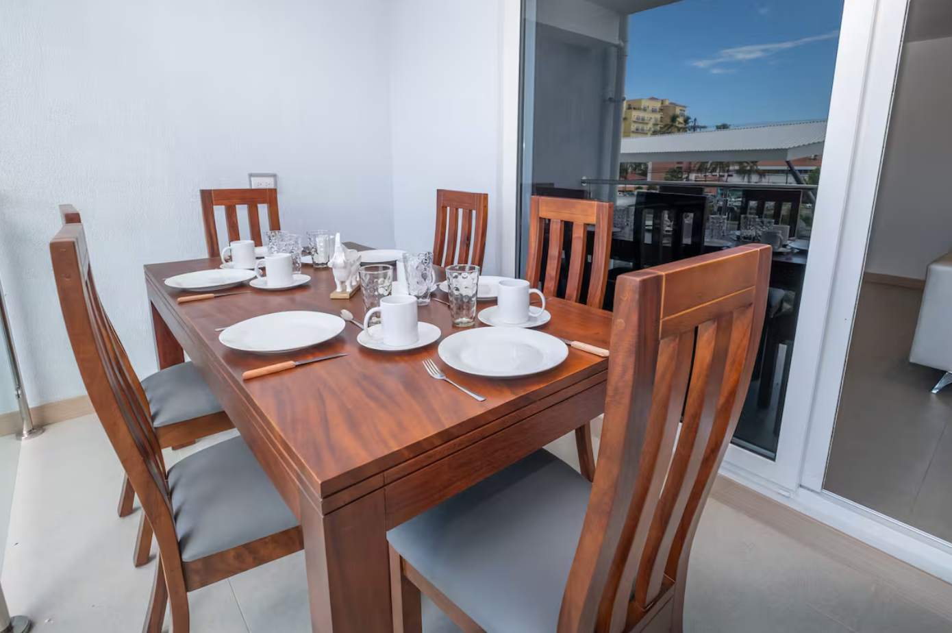 Outdoor balcony dining area with refreshing views