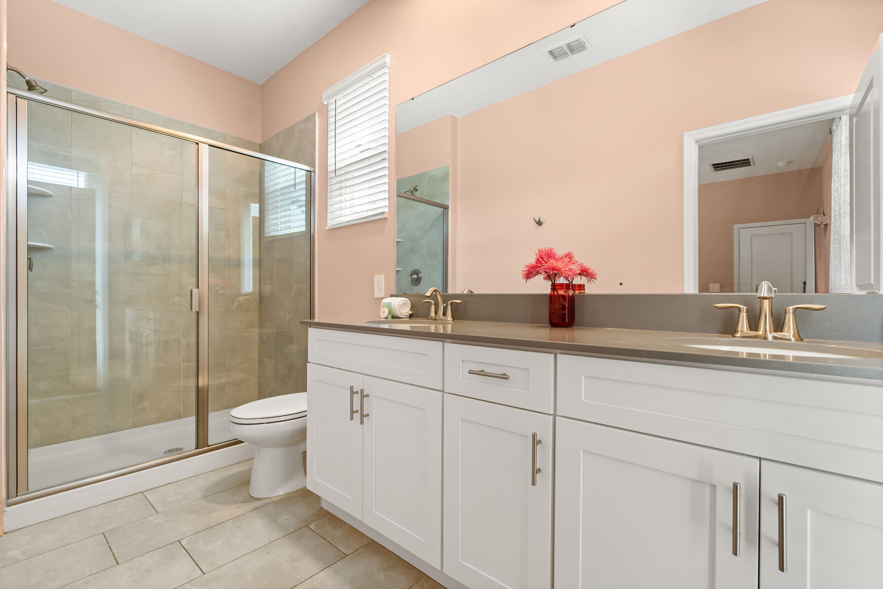Spacious ensuite bathroom with dual sinks and walk-in shower.