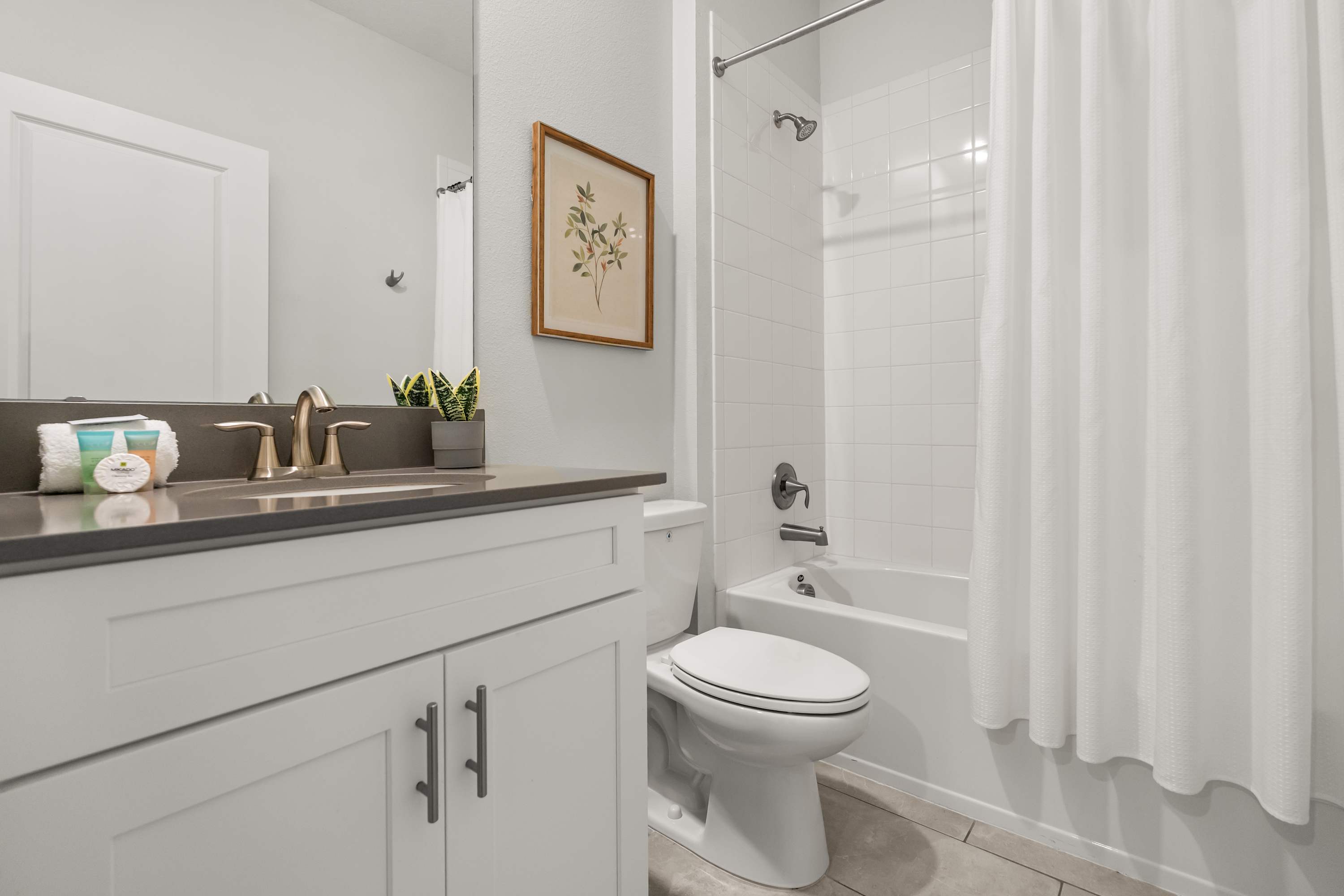 Sparkling clean bathrooms with modern vanities and fresh towels provided.