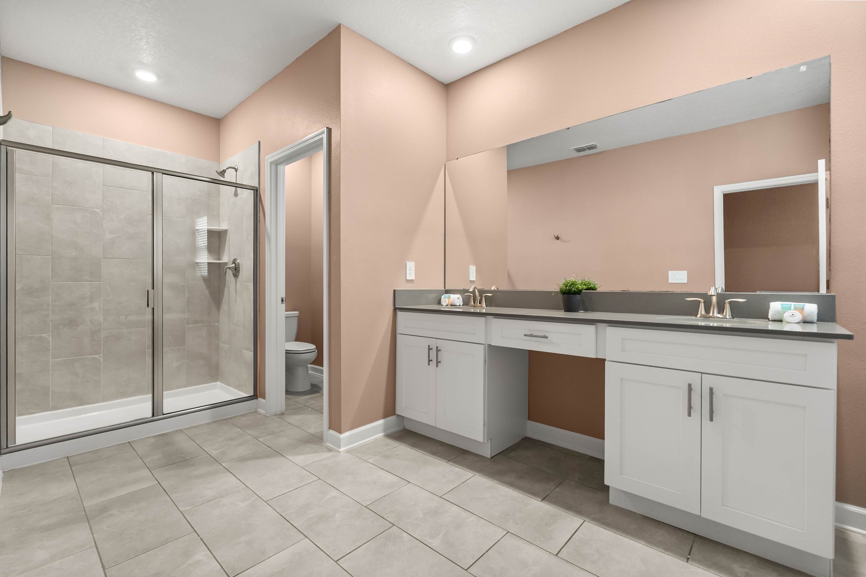 Luxurious ensuite bathroom with dual sinks and walk-in shower