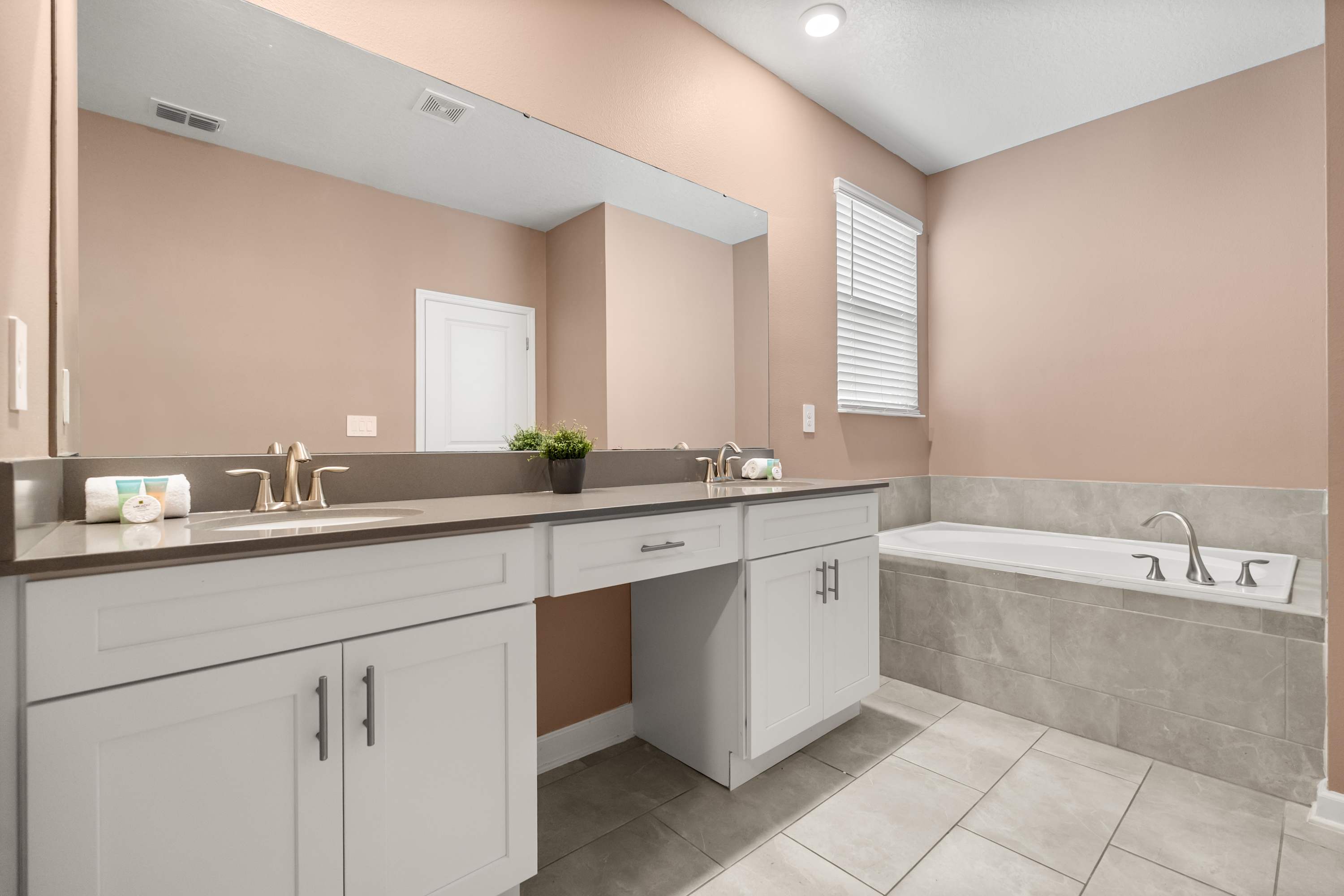 Luxurious ensuite bathroom with dual sinks and walk-in shower