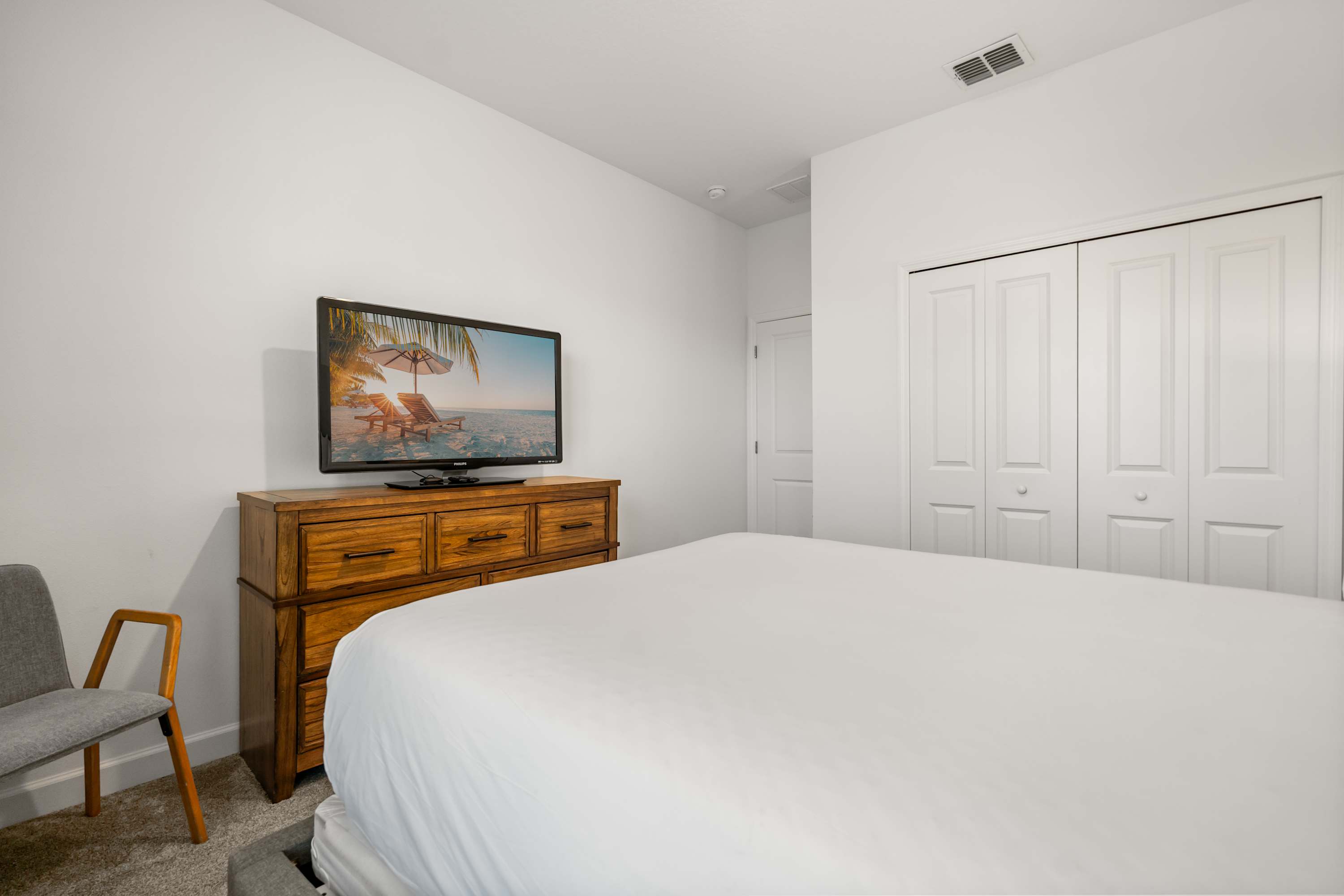 Bright and airy queen bedroom with stylish décor and plenty of natural light.