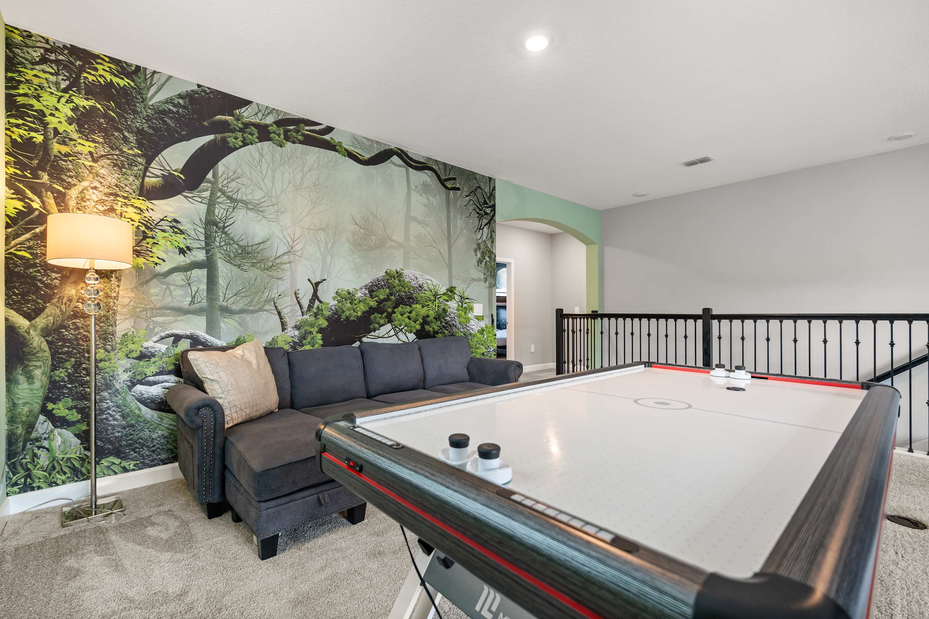 Dedicated game room with foosball and air hockey for endless family fun.
