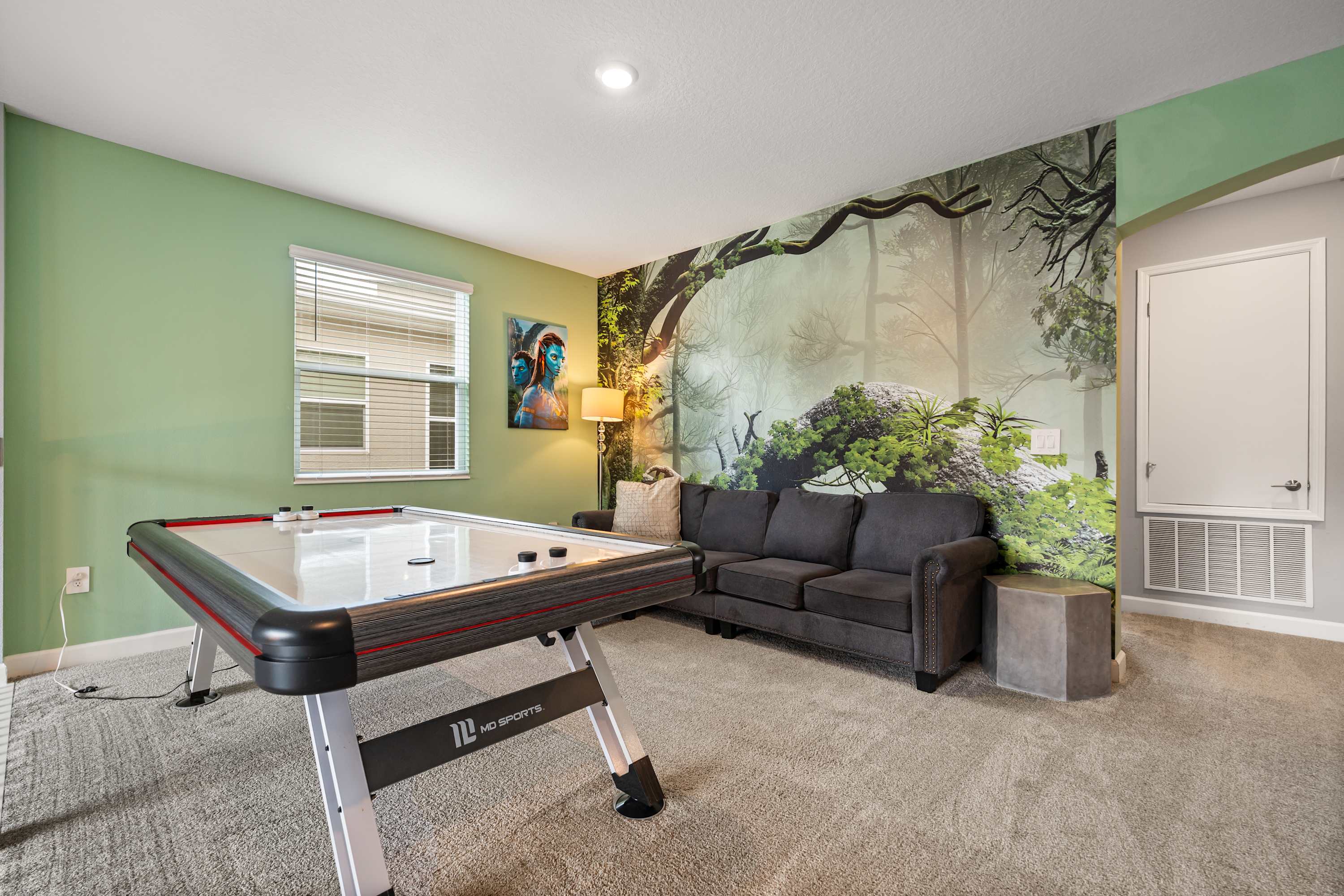 Dedicated game room with foosball and air hockey for endless family fun.