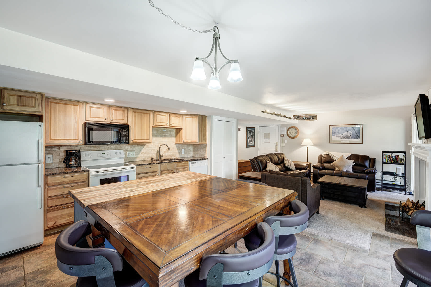 Fully Equipped kitchen with dining counter & modern appliances.