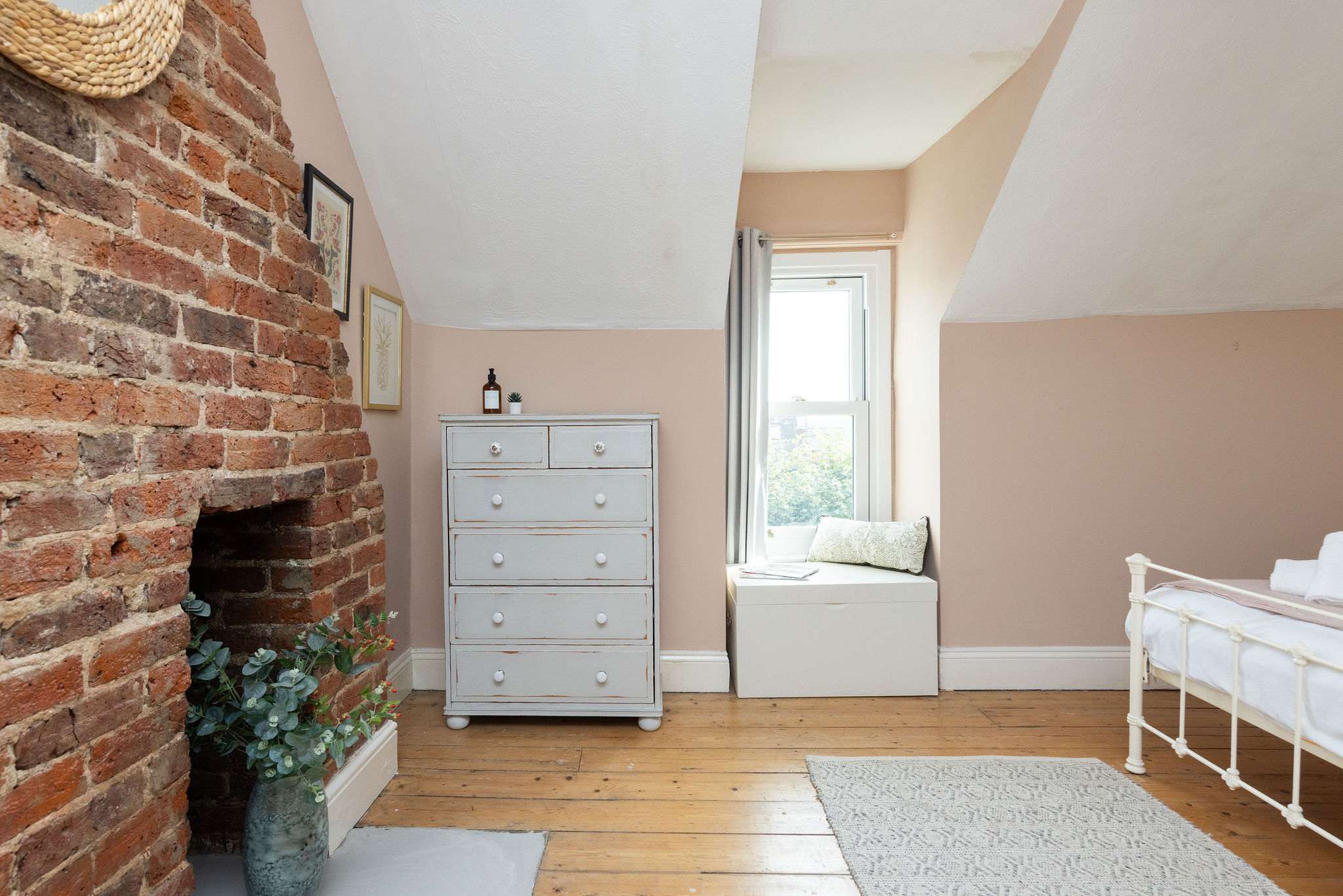 A cosy bedroom corner with a bright window seat.