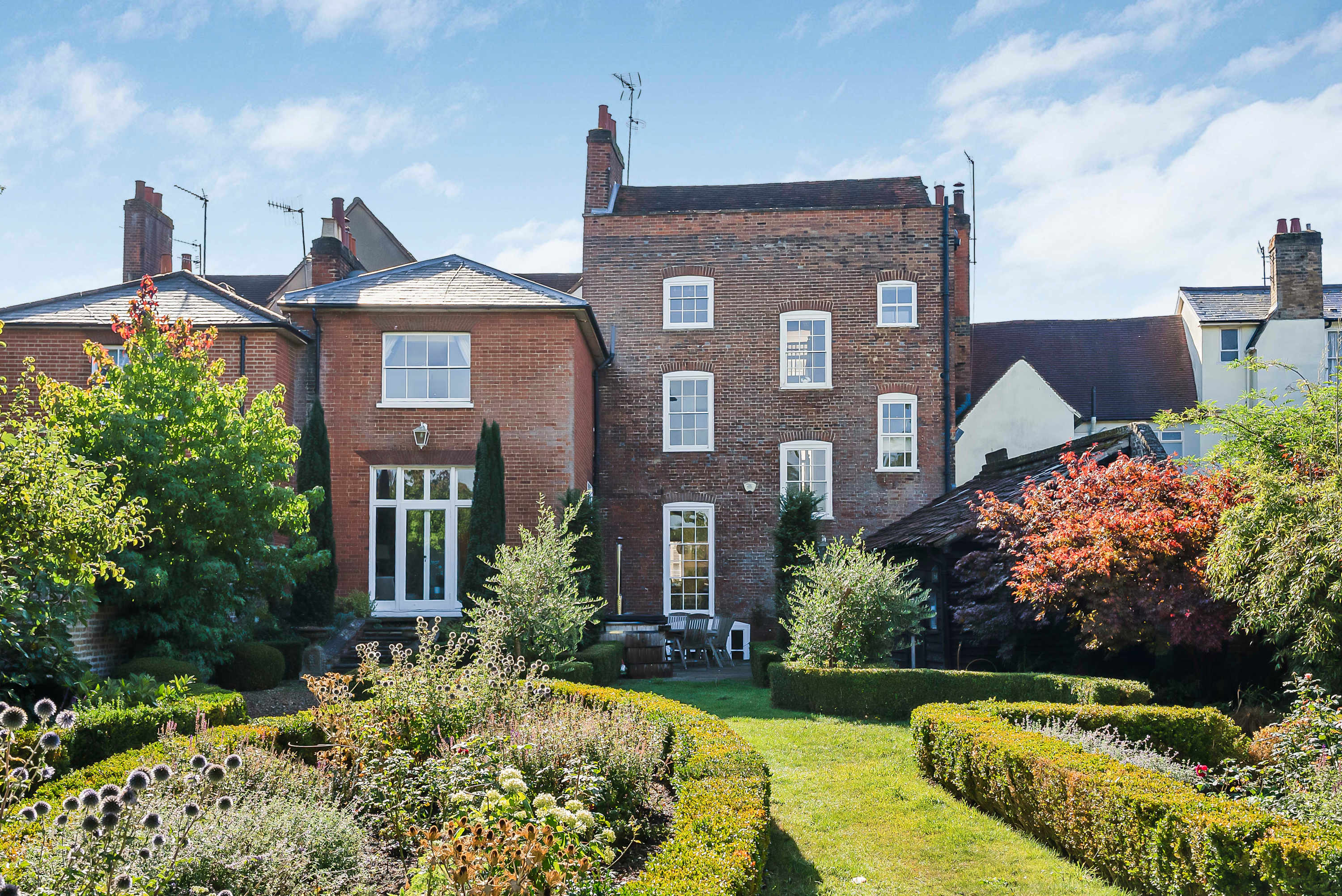 Brick exterior and garden terrace at Squires House in Hertford