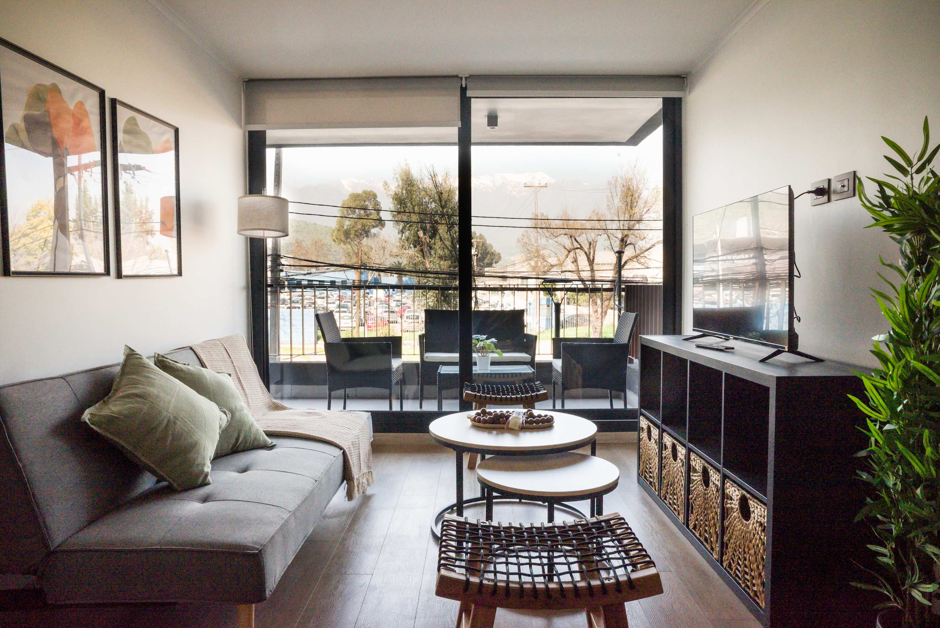 Relax in this chic living room with stunning mountain views from the balcony, perfect for unwinding after a day of adventure.
