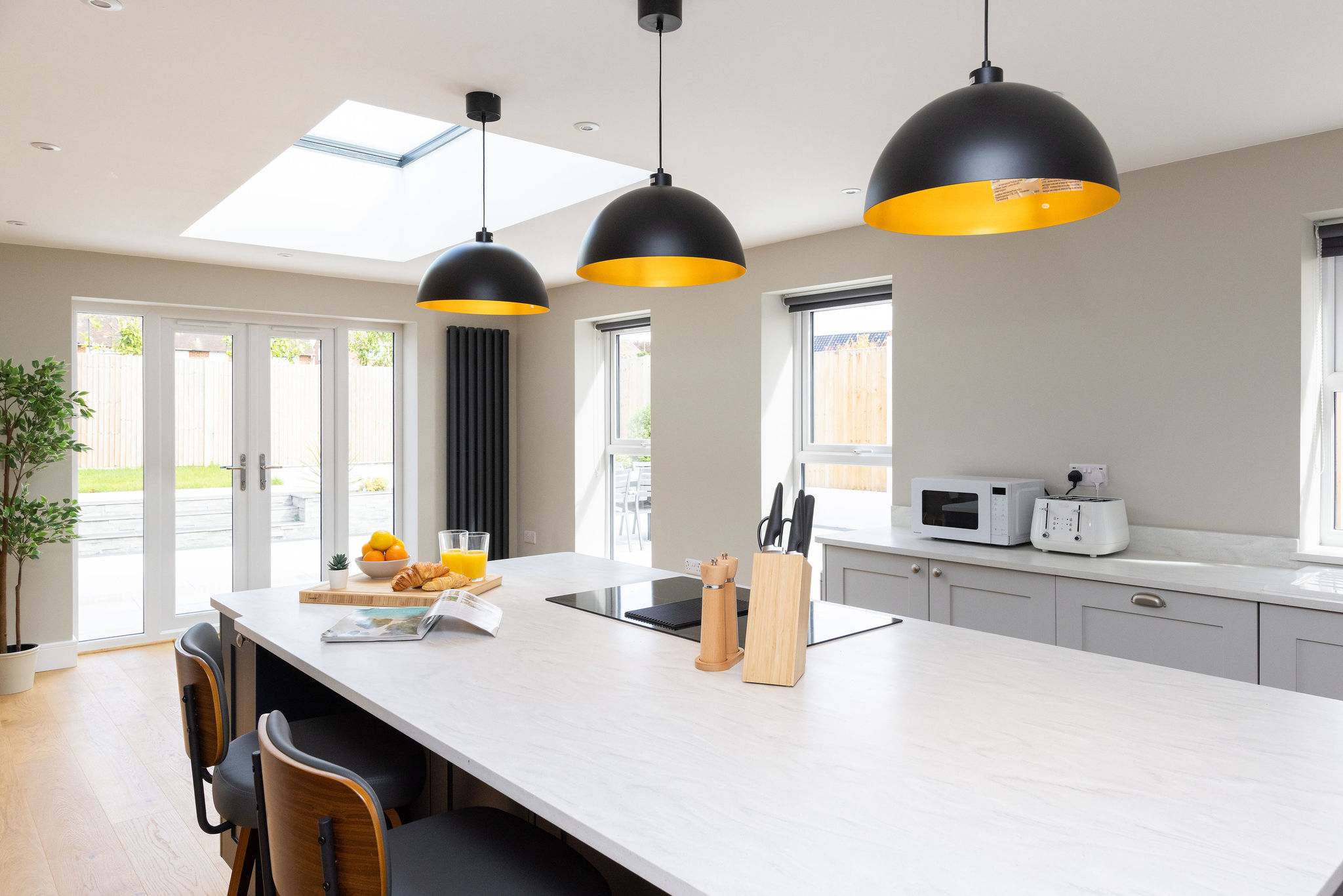 Enjoy garden views from this bright and modern kitchen space.