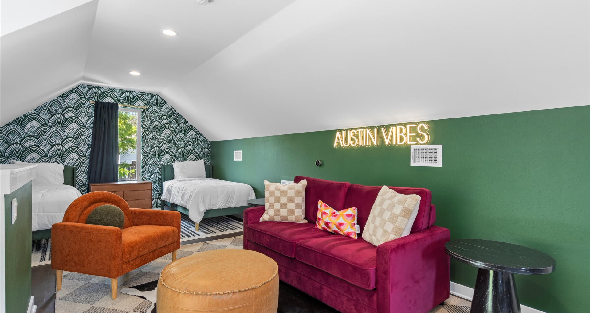 Vibrant bedroom featuring four single beds, styled with bold tones of olive green, burnt orange, and rich burgundy furnishings—perfect for groups who want both comfort and personality in their stay.