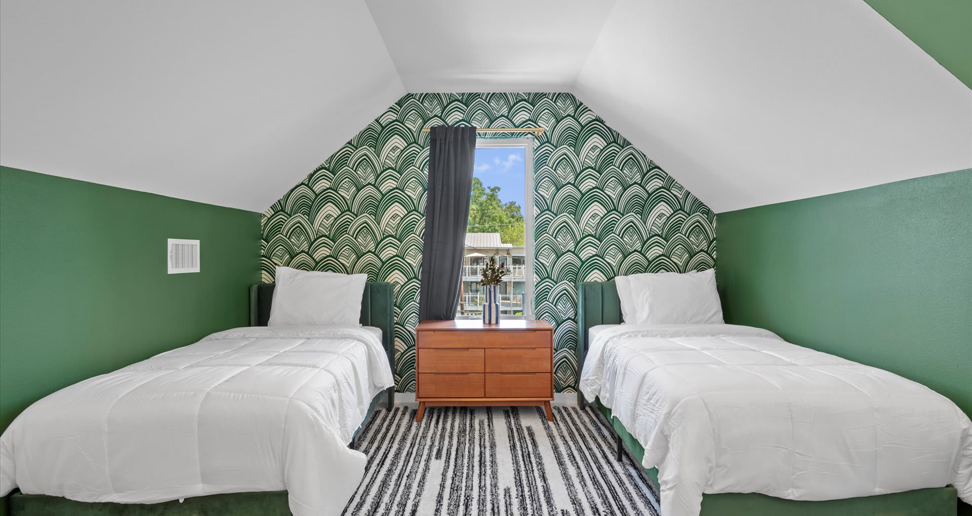 Vibrant bedroom featuring four single beds, styled with bold tones of olive green, burnt orange, and rich burgundy furnishings