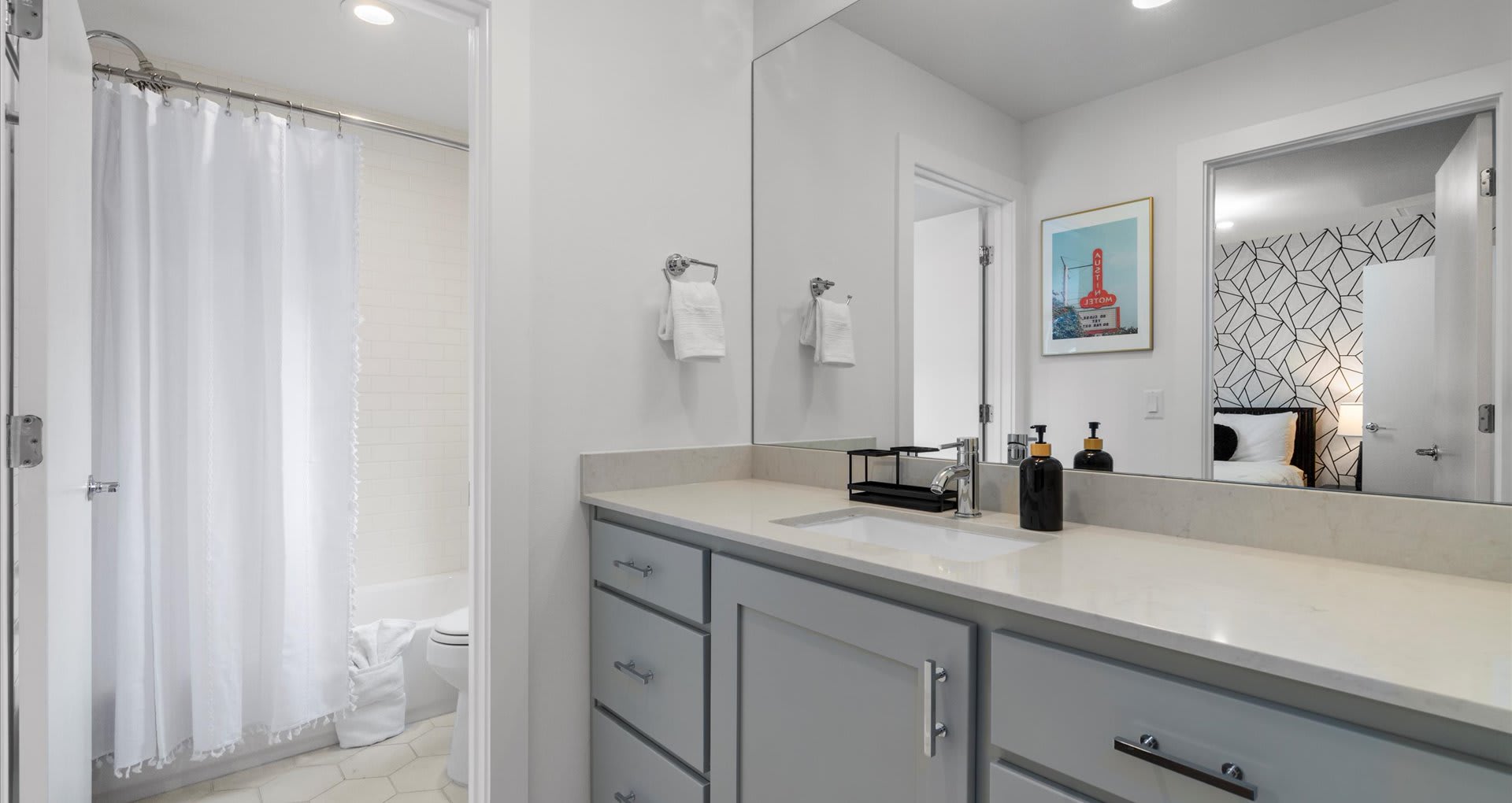 Full bathroom with spacious vanity and shower