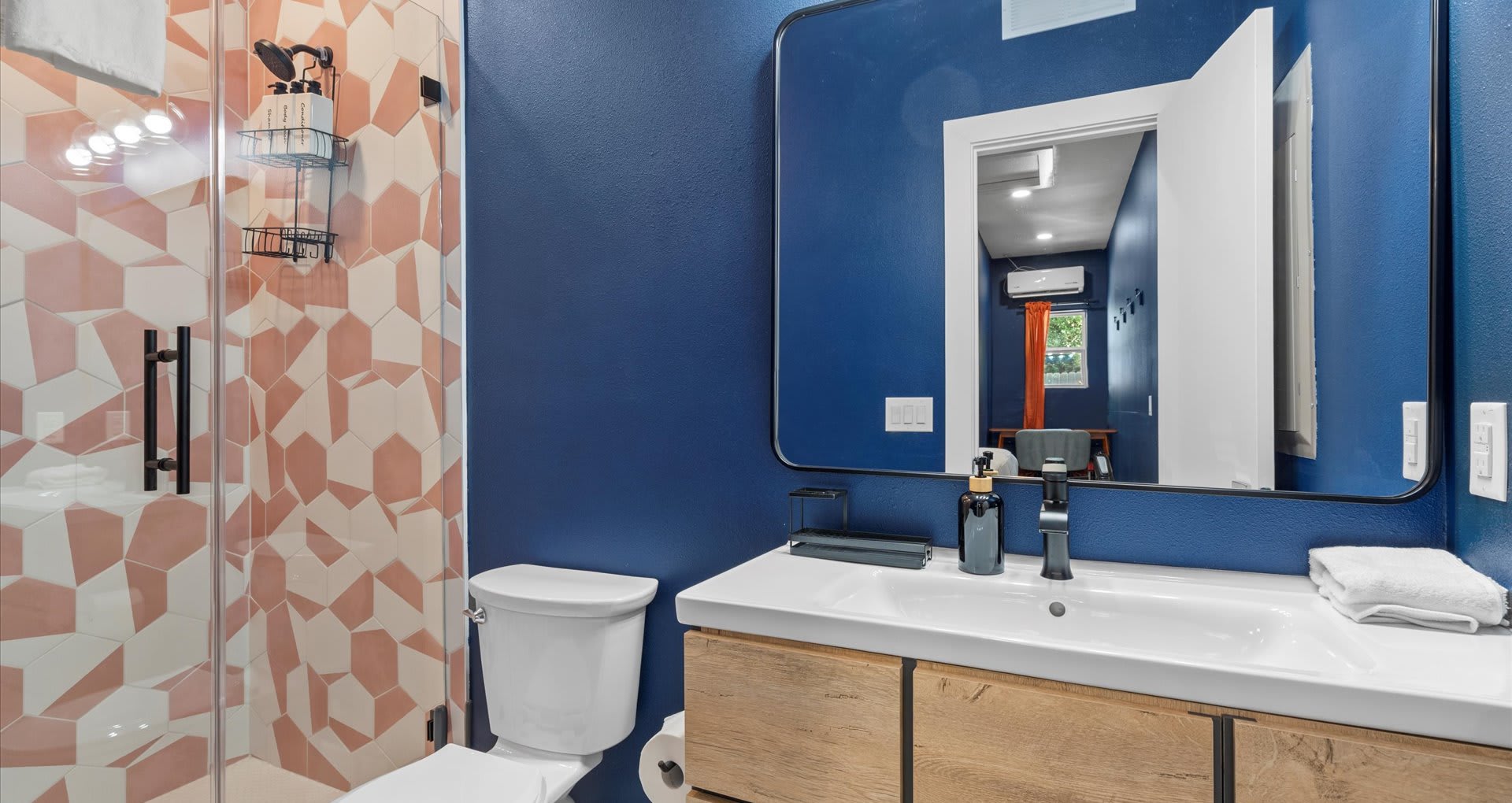 Modern en-suite bathroom with stunning vanity and glass standing shower