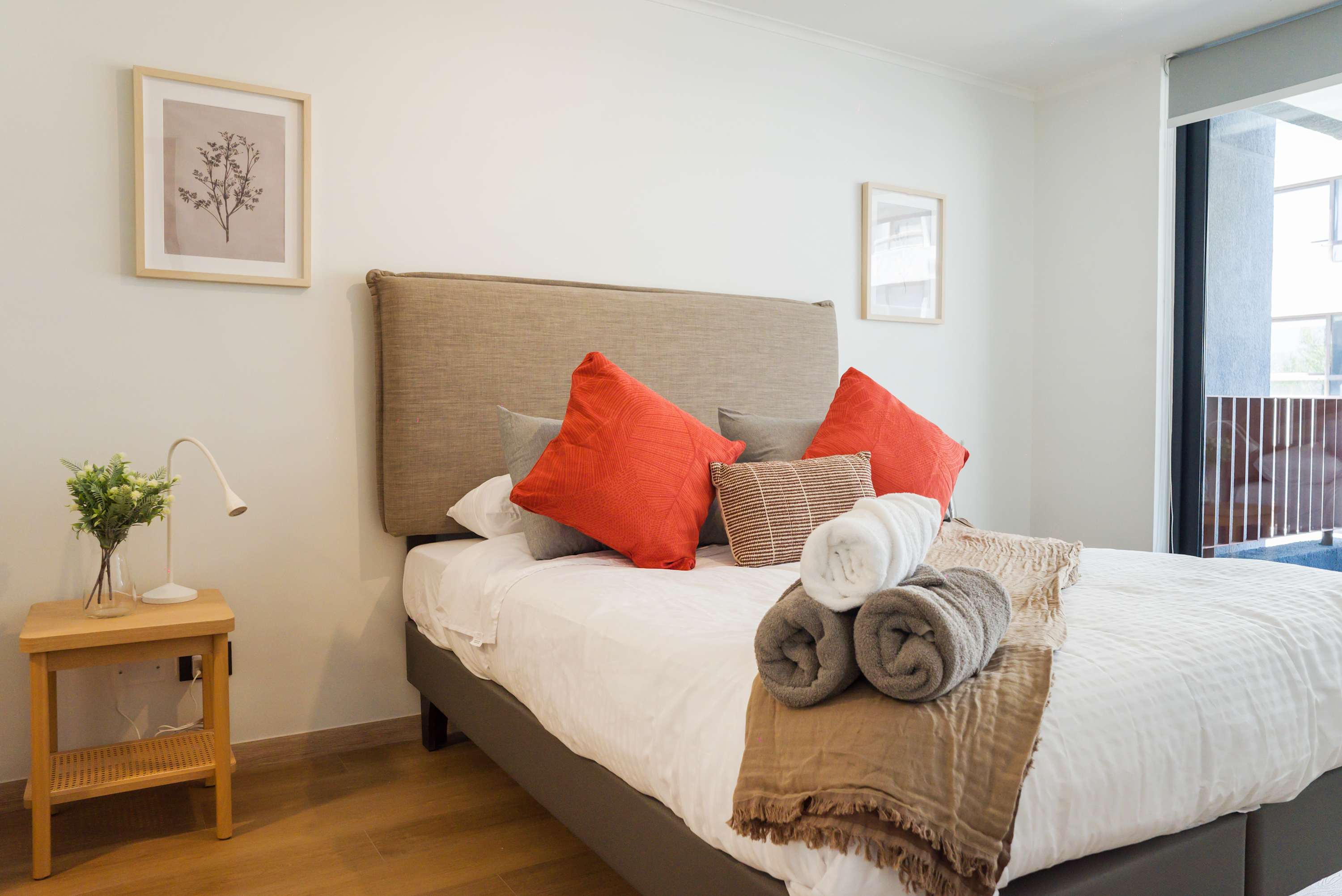 Unwind in this inviting bedroom with plush pillows and soothing natural light, perfect for a restful retreat.