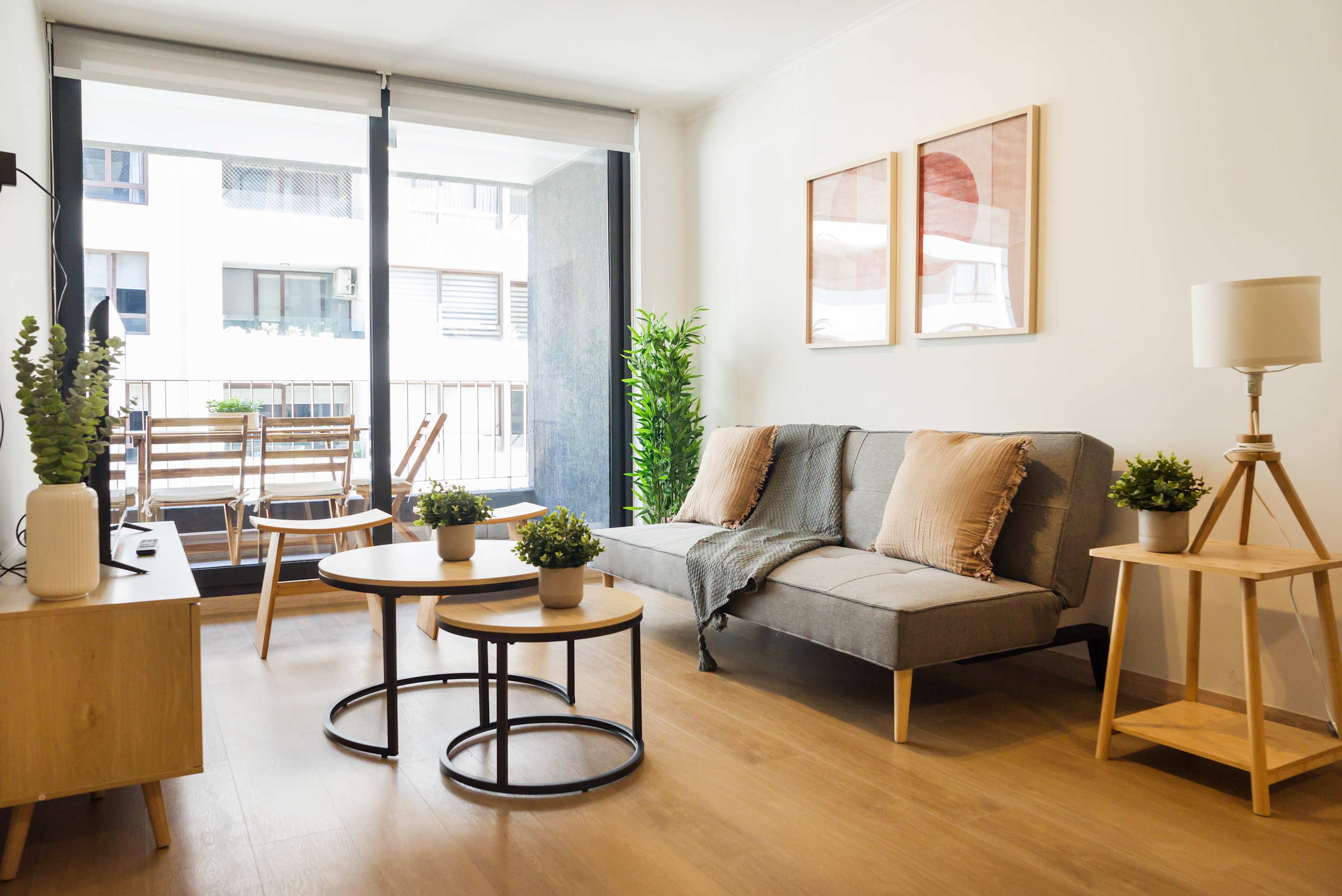 Cozy living area with modern decor and balcony access, perfect for relaxation in a stylish setting.