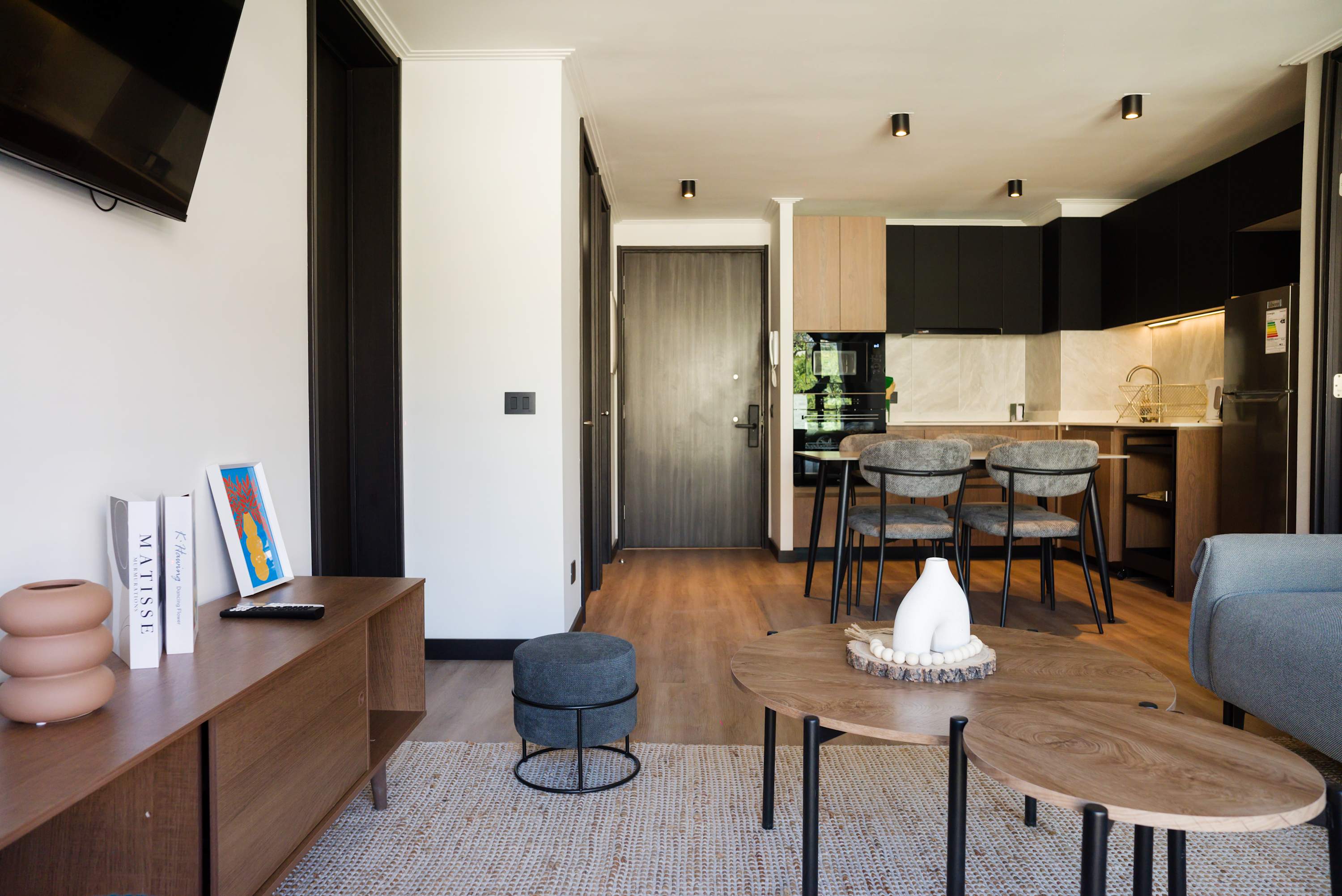 Stylish and modern living area with a cozy dining space and sleek kitchen, perfect for relaxing and entertaining.