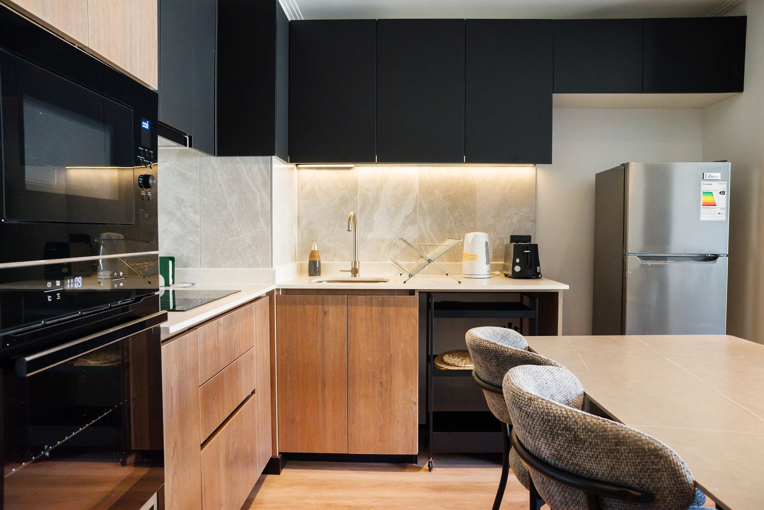 Modern kitchen with sleek appliances and ample counter space, perfect for culinary adventures.