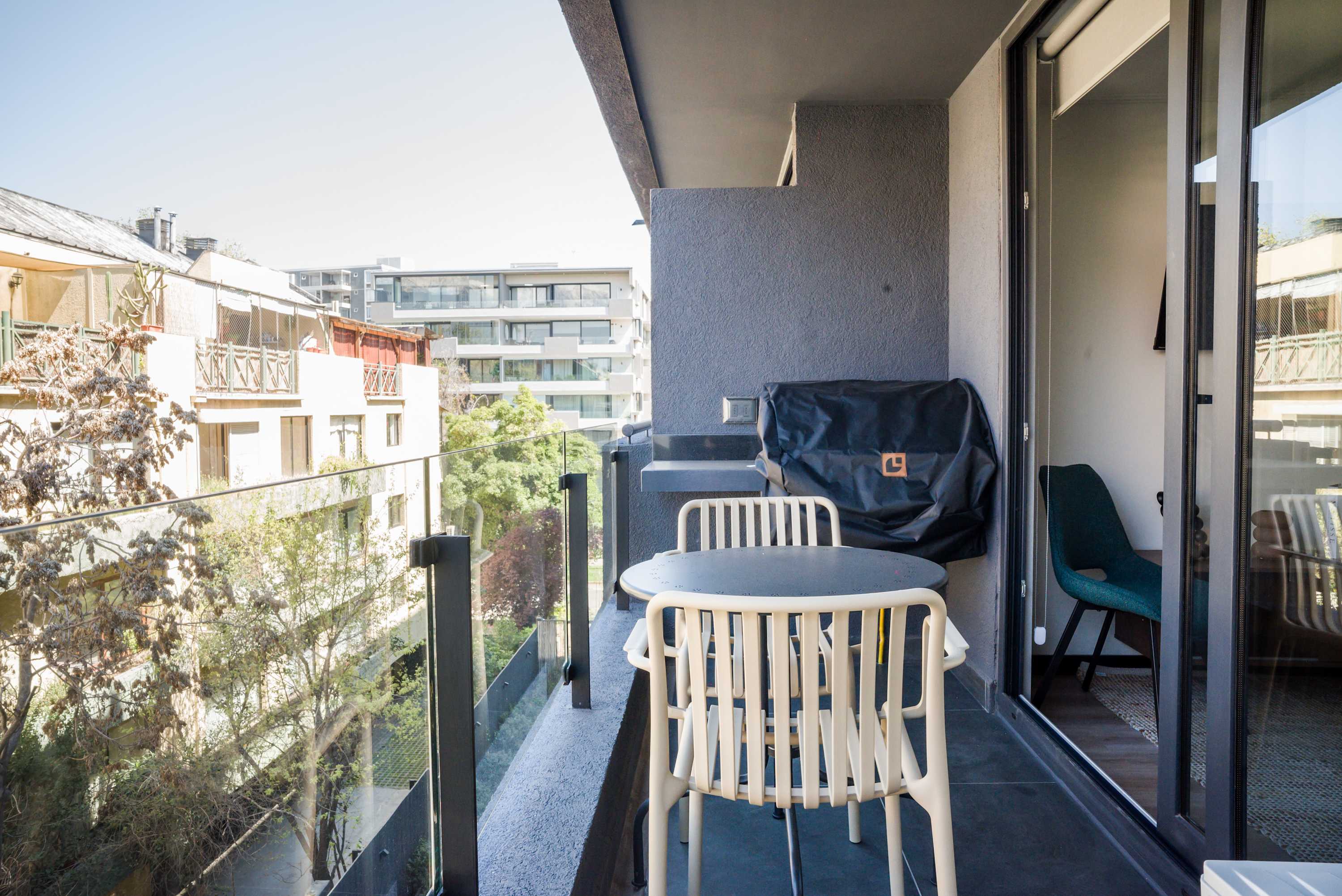 Enjoy outdoor dining on your private balcony with city views and a convenient grill for barbecues.